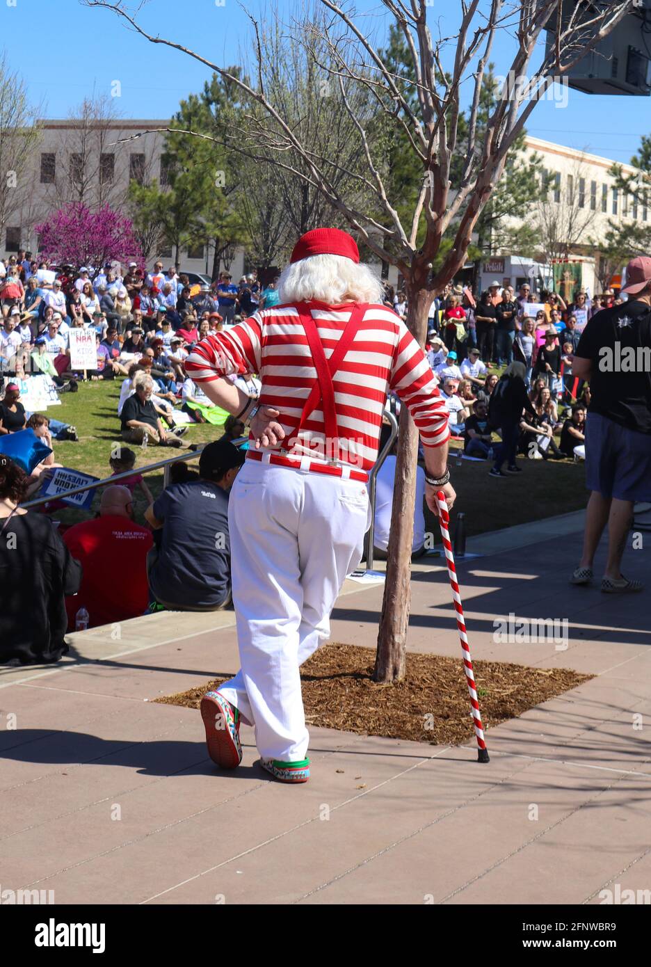 Back of white haired man with bright red and white clothing and cane at March for Life Tulsa Oklahoma USA 3 24 2018 Stock Photo