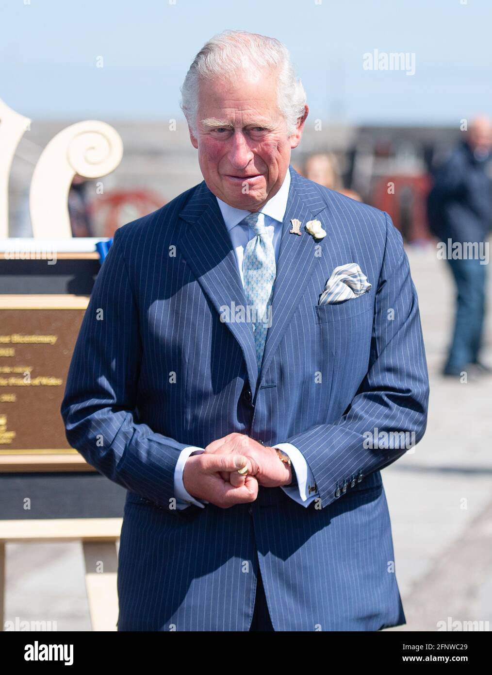 The Prince of Wales during a visit to Donaghadee Harbour where he viewed stones which line the harbour walls and were decorated with messages of hope by local people during the pandemic. The prince also unveiled a plaque to commemorate the Bicentenary of the Royal Charter of Donaghadee Harbour and the laying of the harbour's foundation stone. Picture date: Wednesday May 19, 2021. Stock Photo