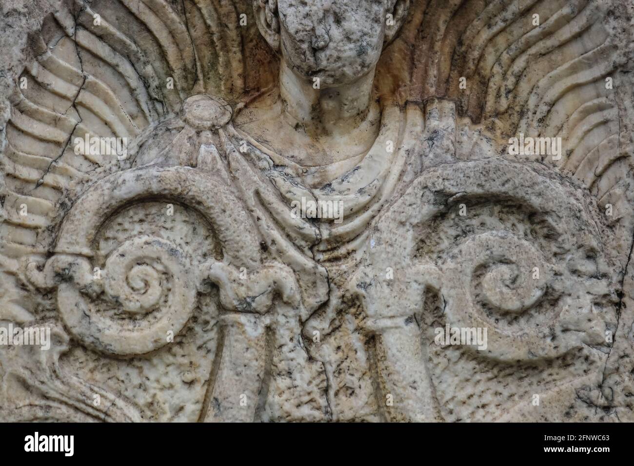 Background of closeup of beautiful Roman or Greek male stylized angel with cracks and face crumbled off - beautiful and grungy Stock Photo