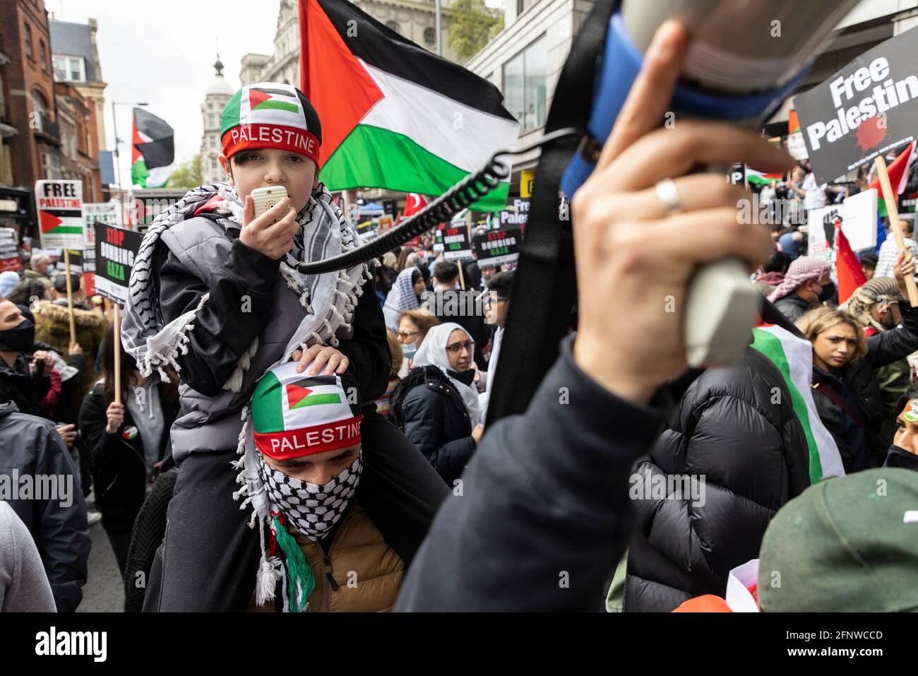 A child speaking into megaphone in a crowd, 'Free Palestine' solidarity protest, London, 15 May 2021 Stock Photo