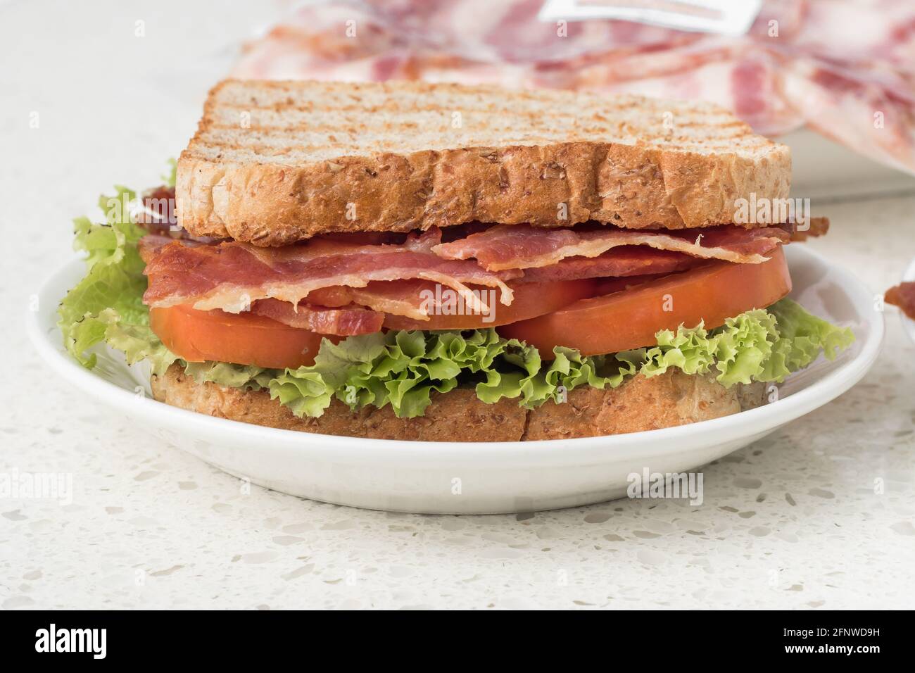Grilled BLT Sandwich with bacon, tomato, lettuce, and whole wheat bread Stock Photo