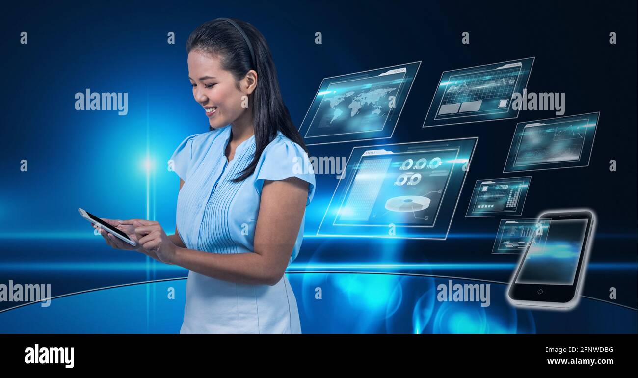 Composition of smiling businesswoman using smartphone over digital screens with data processing Stock Photo