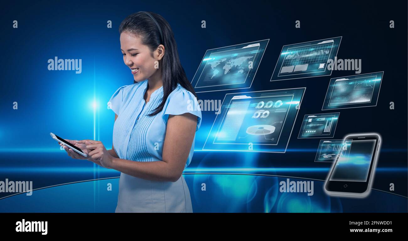 Composition of smiling businesswoman using smartphone over digital screens with data processing Stock Photo