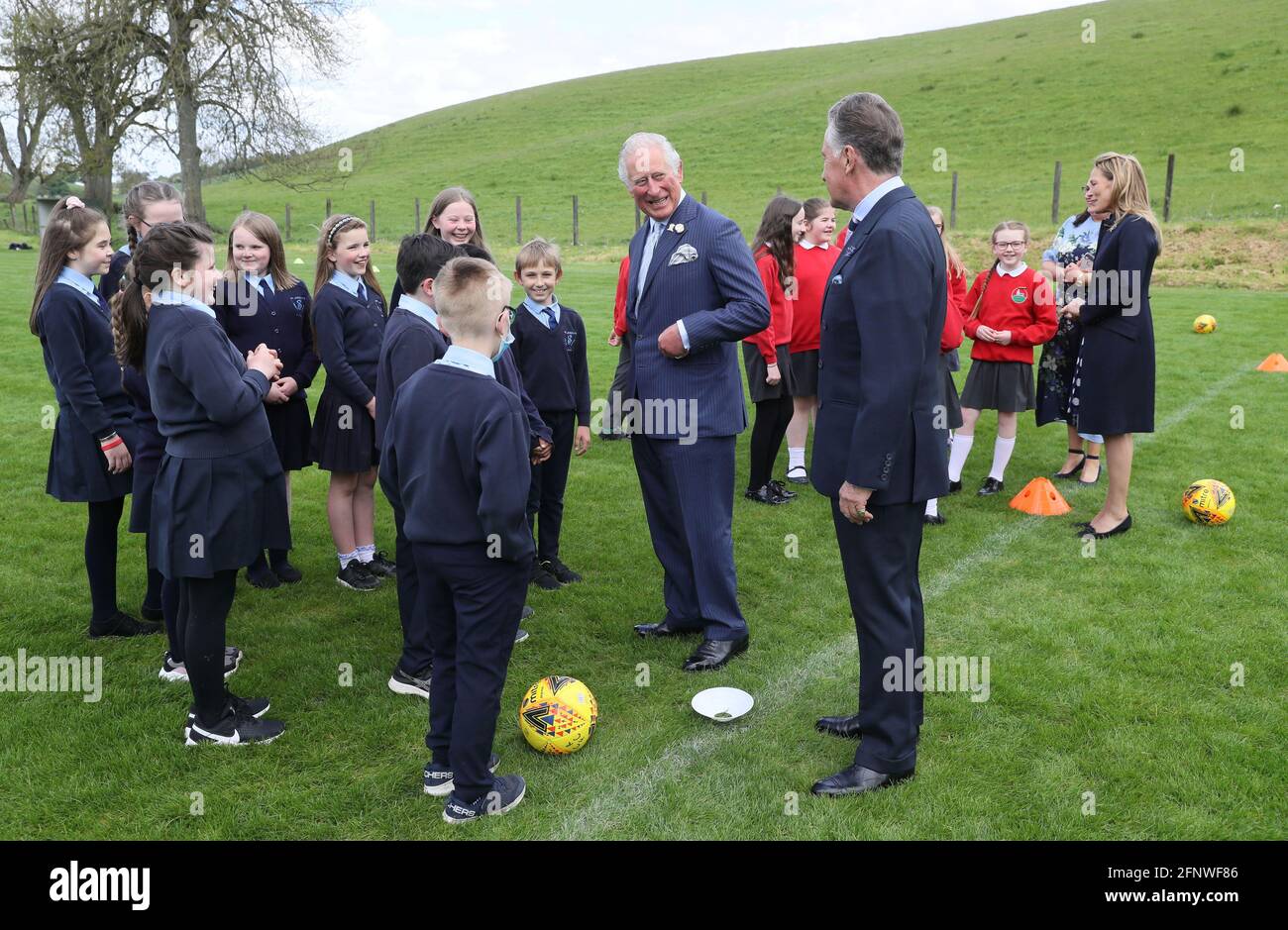 Britain's Prince Charles with Lord Caledon meet children at Caledon Rovers FC pitch, during his visit to Caledon, Northern Ireland May 19, 2021. Brian Lawless/PA Wire/Pool via REUTERS Stock Photo
