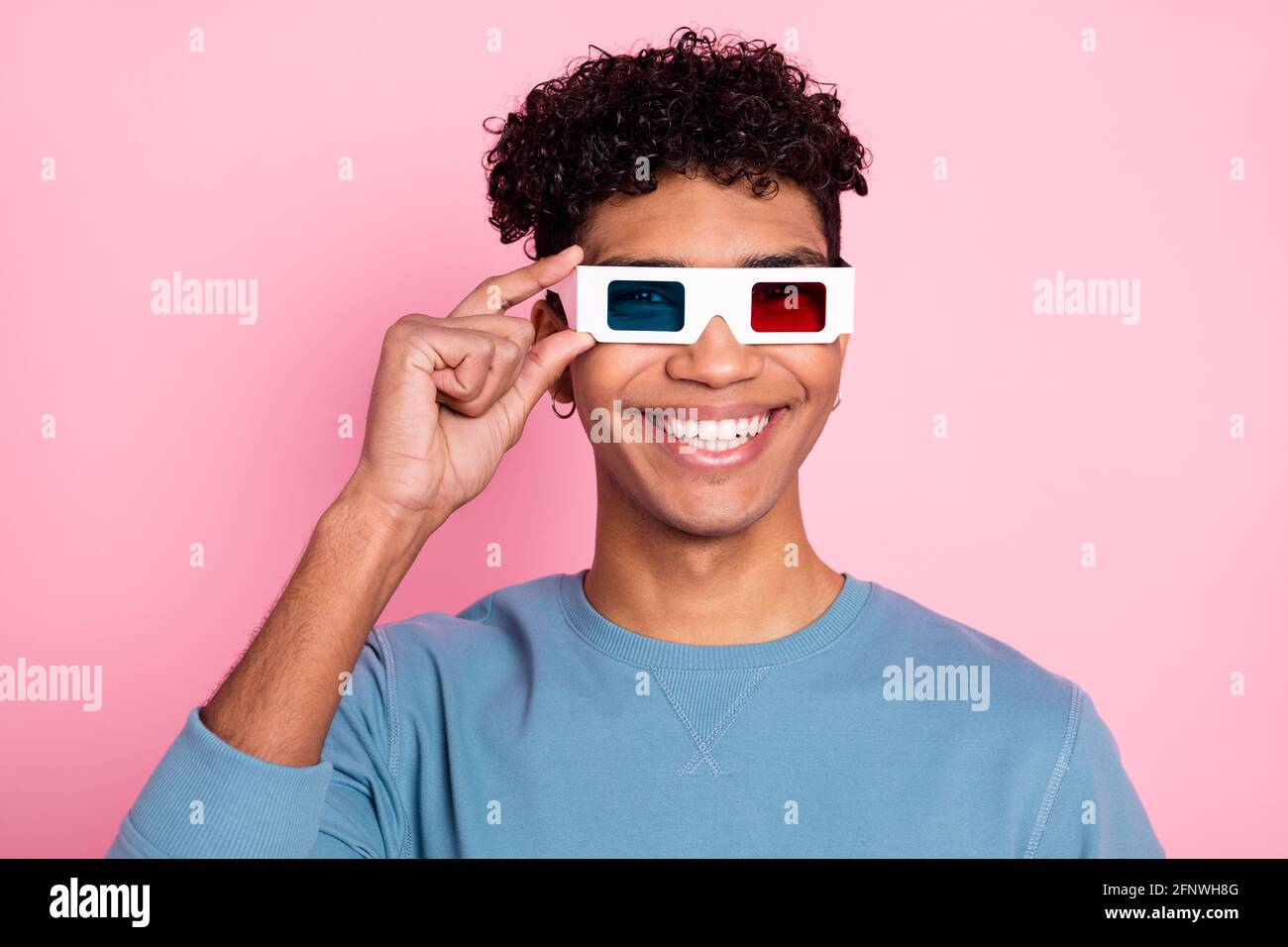 Photo of young black man happy positive smile hand touch 3d glasses watch  film isolated over pink color background Stock Photo - Alamy
