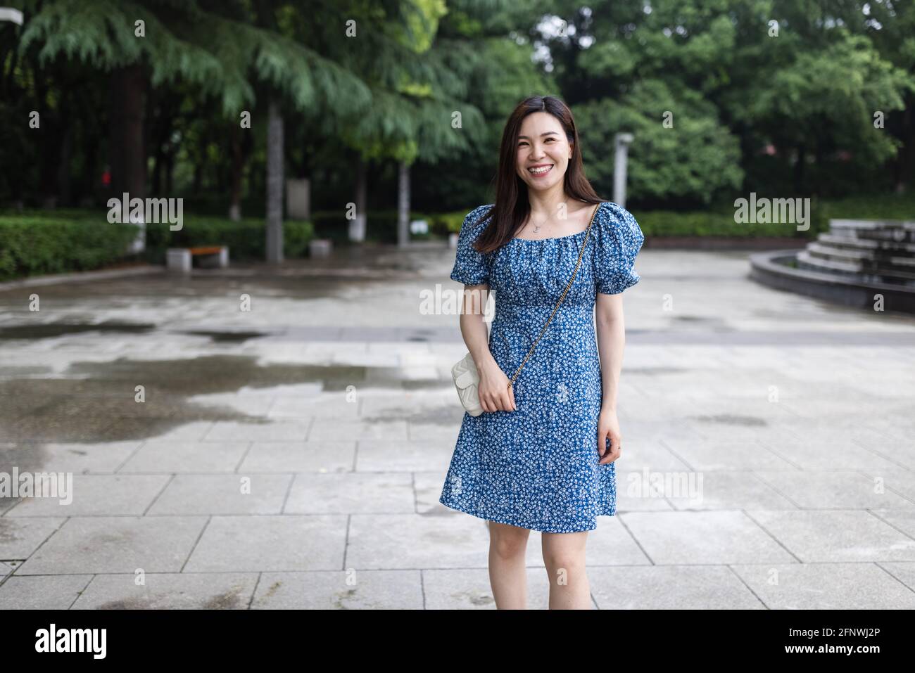Portrait of young asian woman wearing stylish summer dress and walking  outdoor in city. Happy stylish woman with smiley face enjoys life Stock  Photo - Alamy