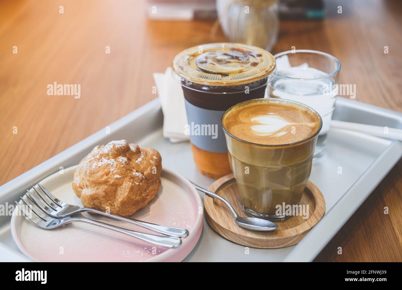 Coffee order surve set in the tray on the wooden table with morning lighting. Stock Photo