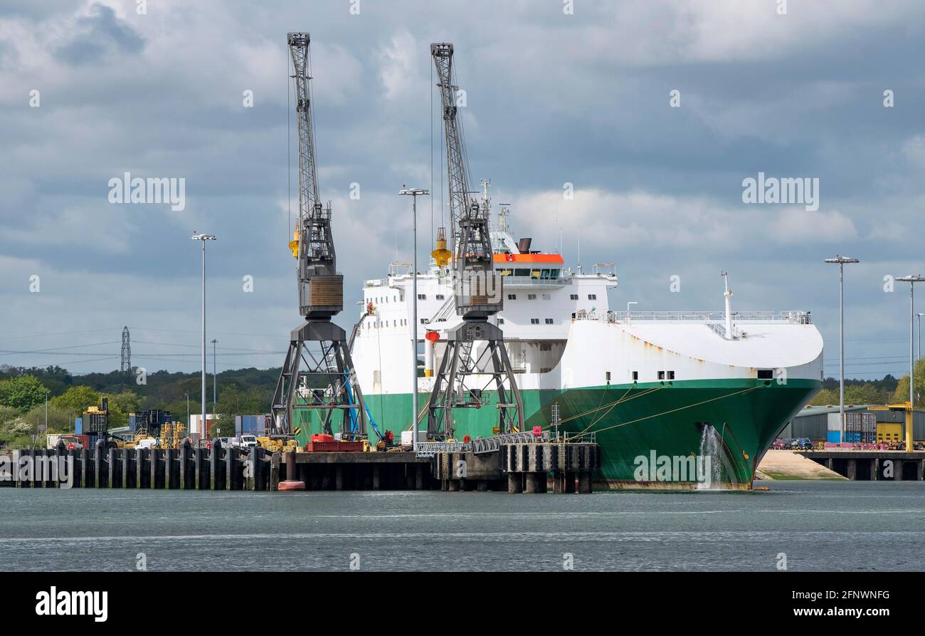 Marchwood, Southampton, England, UK. 2021.  Two cranes tower over the roro Hurst Point a military supplies ship at Marchwood, Southampton Water, Engla Stock Photo