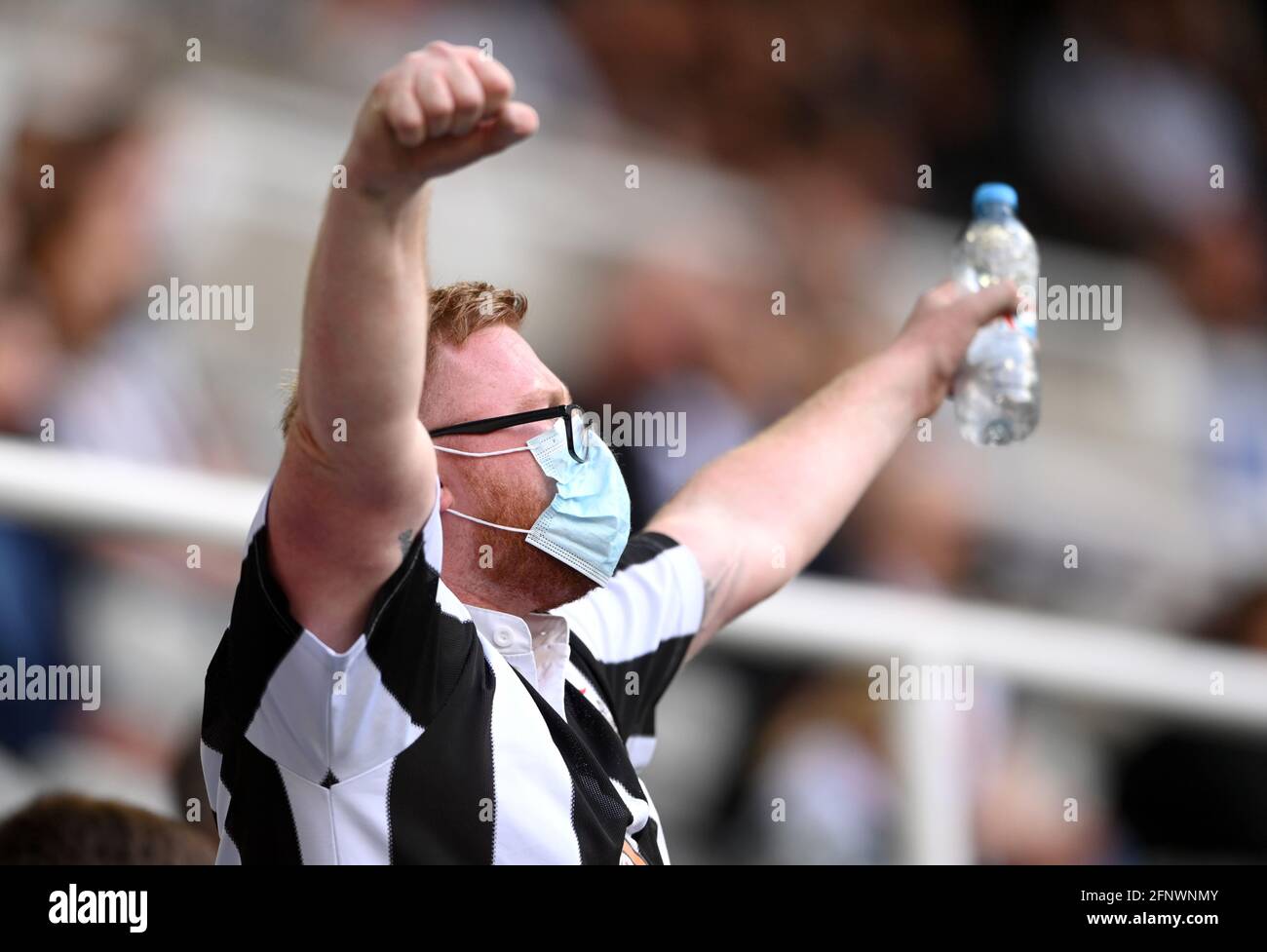 Newcastle United fan show their support in the stands during the Premier League match at St. James' Park, Newcastle upon Tyne. Picture date: Wednesday May 19, 2021. Stock Photo
