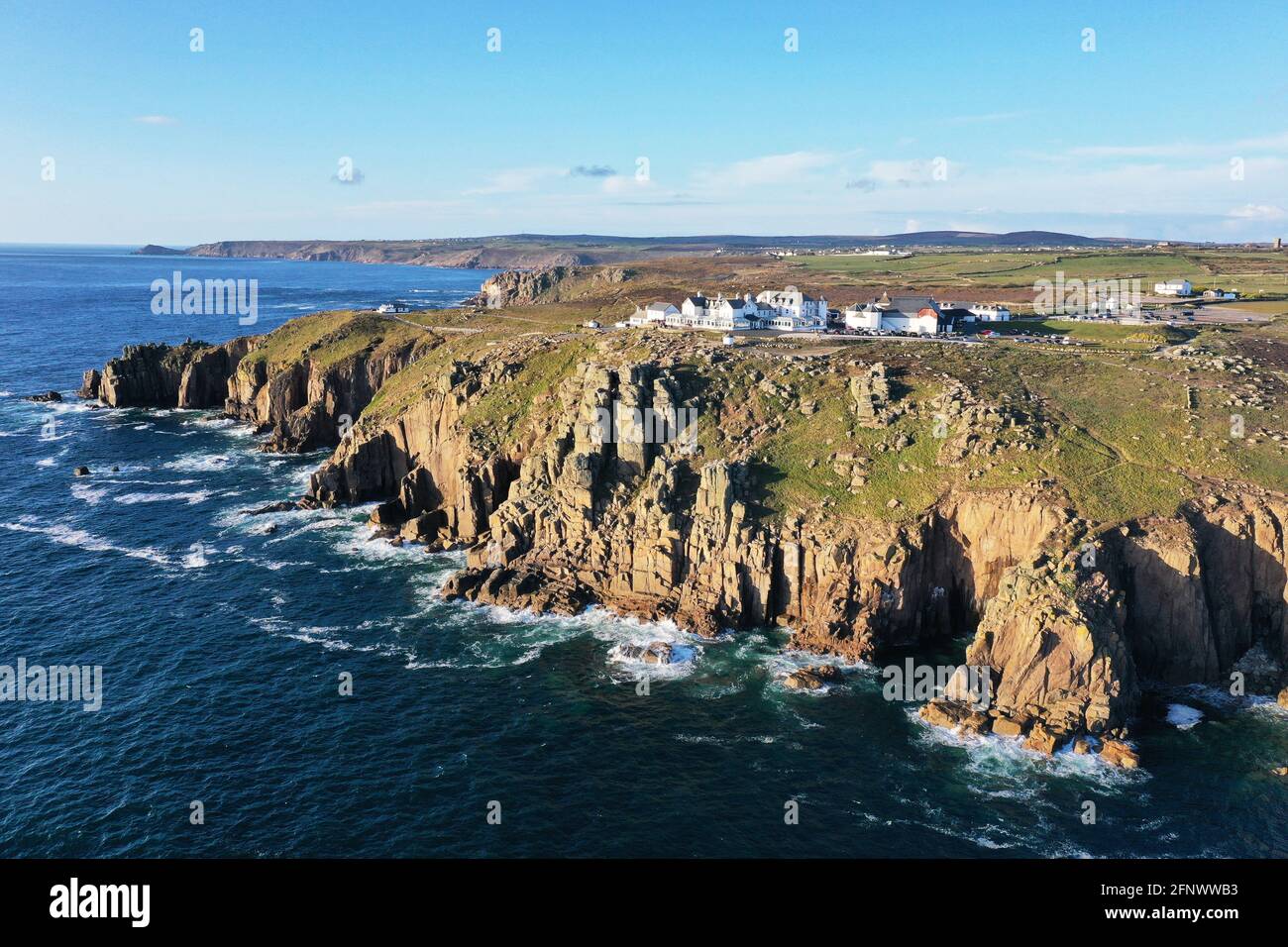 beautiful aerial view of lands end Cornwall with the ocean, cliffs and rugged coastline on a sunny day Stock Photo