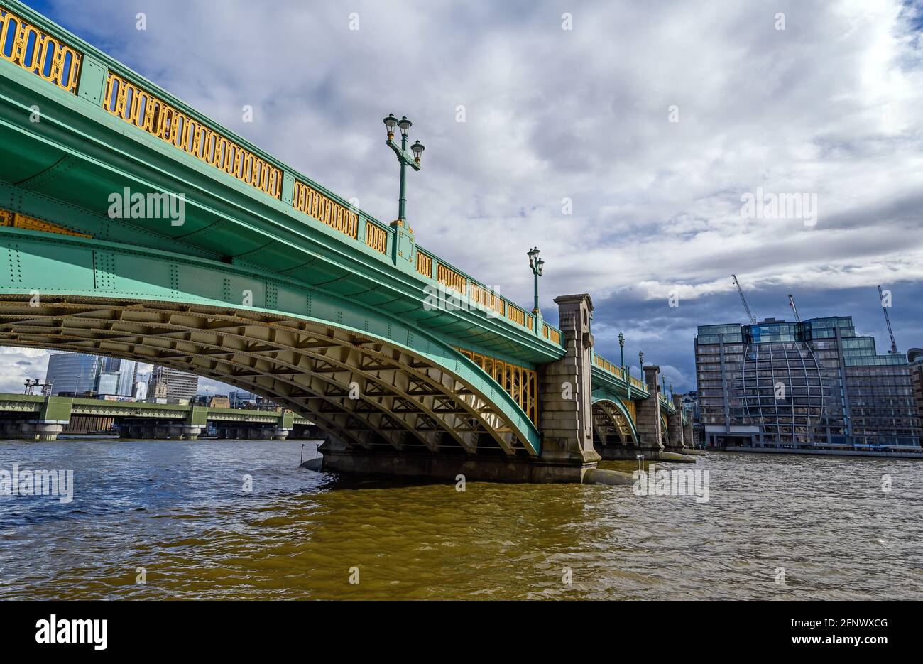 Southwark Bridge and River Thames in London, UK looking towards the south bank and Southwark. Beyond is the rail bridge to Cannon Street Station. Stock Photo