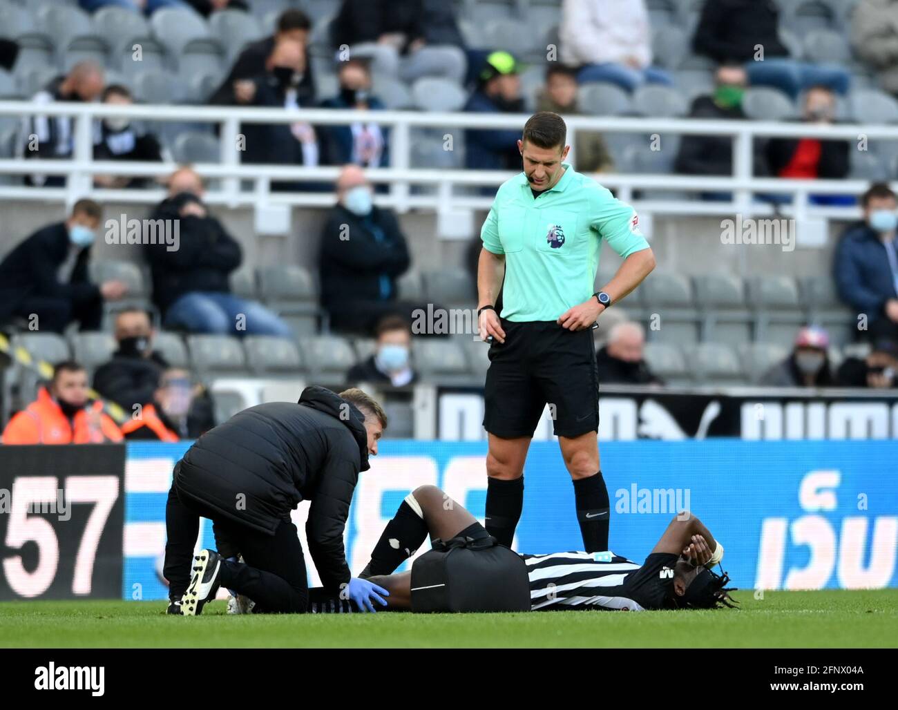 Newcastle United's Allan Saint-Maximin receives medical attention during the Premier League match at St. James' Park, Newcastle upon Tyne. Picture date: Wednesday May 19, 2021. Stock Photo