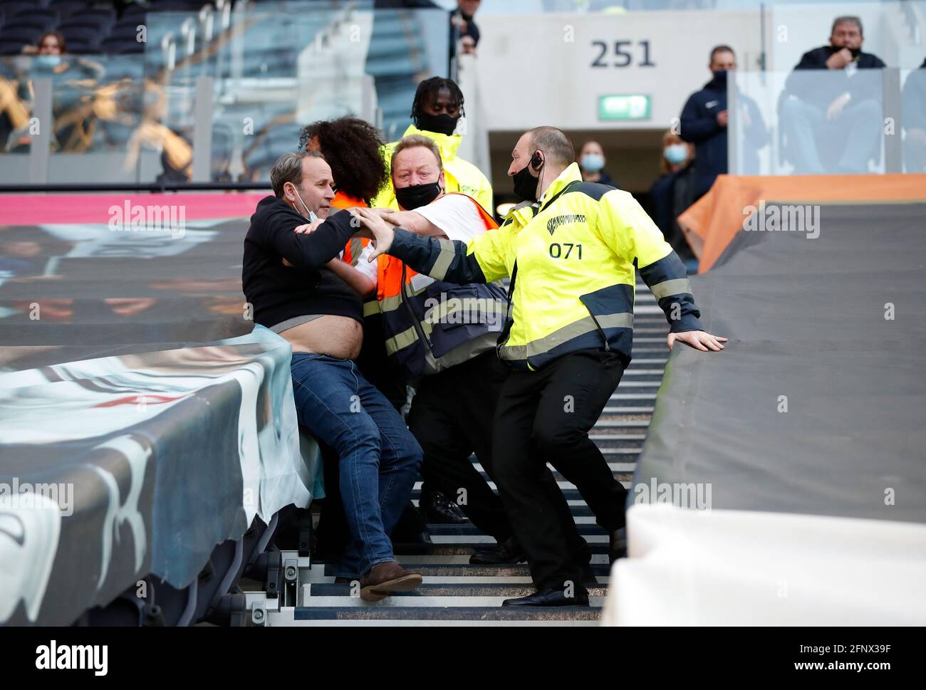 Stewards clash with fans as they refuse to leave the stadium after the final whistle during the Premier League match at the Tottenham Hotspur Stadium, London. Picture date: Wednesday May 19, 2021. Stock Photo