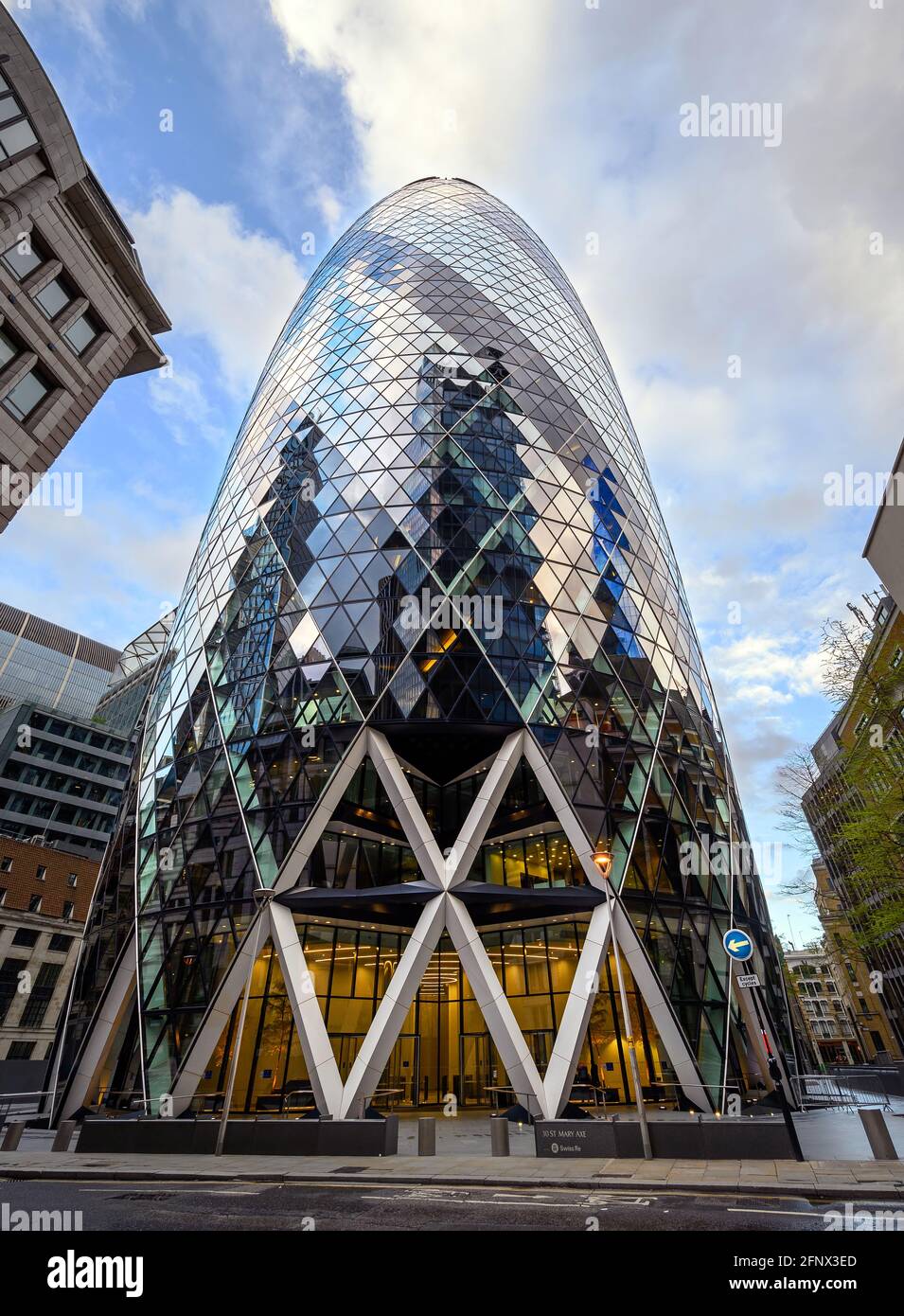 London, UK: Gherkin building in the City of London. View of the Gherkin or 30 St Mary Axe with very wide angle and perspective distortion. Stock Photo