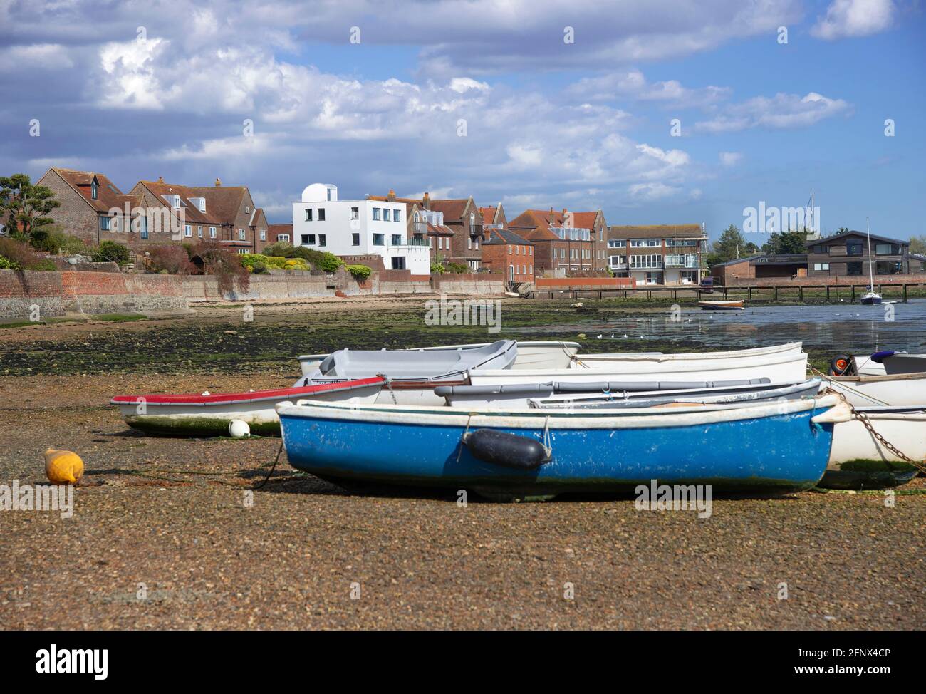 Tenders and small boats at low tide on the waterfront  at Emsworth Habour, Hampshire, part of Chichester Harbour, England, UK Stock Photo