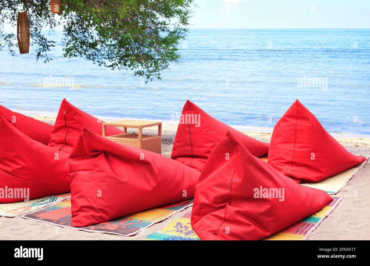 A lot of Bean bags and table set on the beach Stock Photo