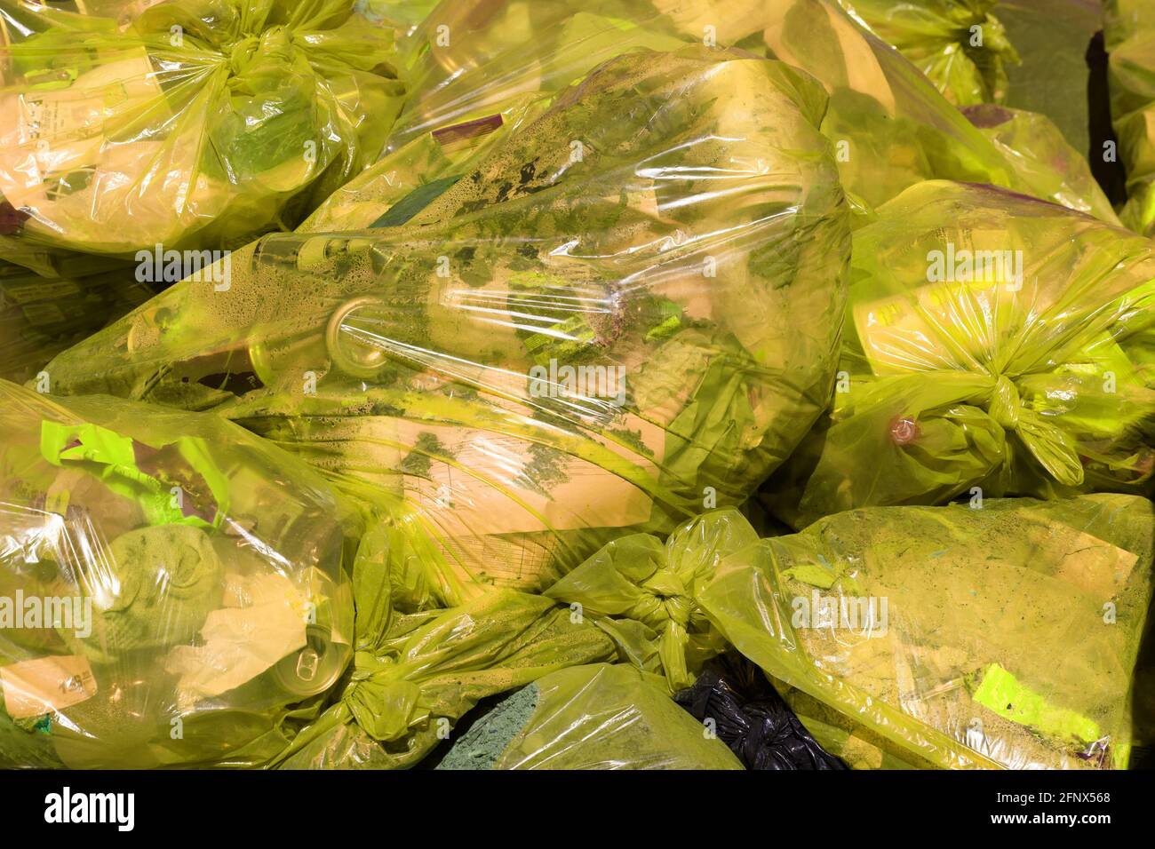 Yellow bags full of plastic waste Stock Photo - Alamy