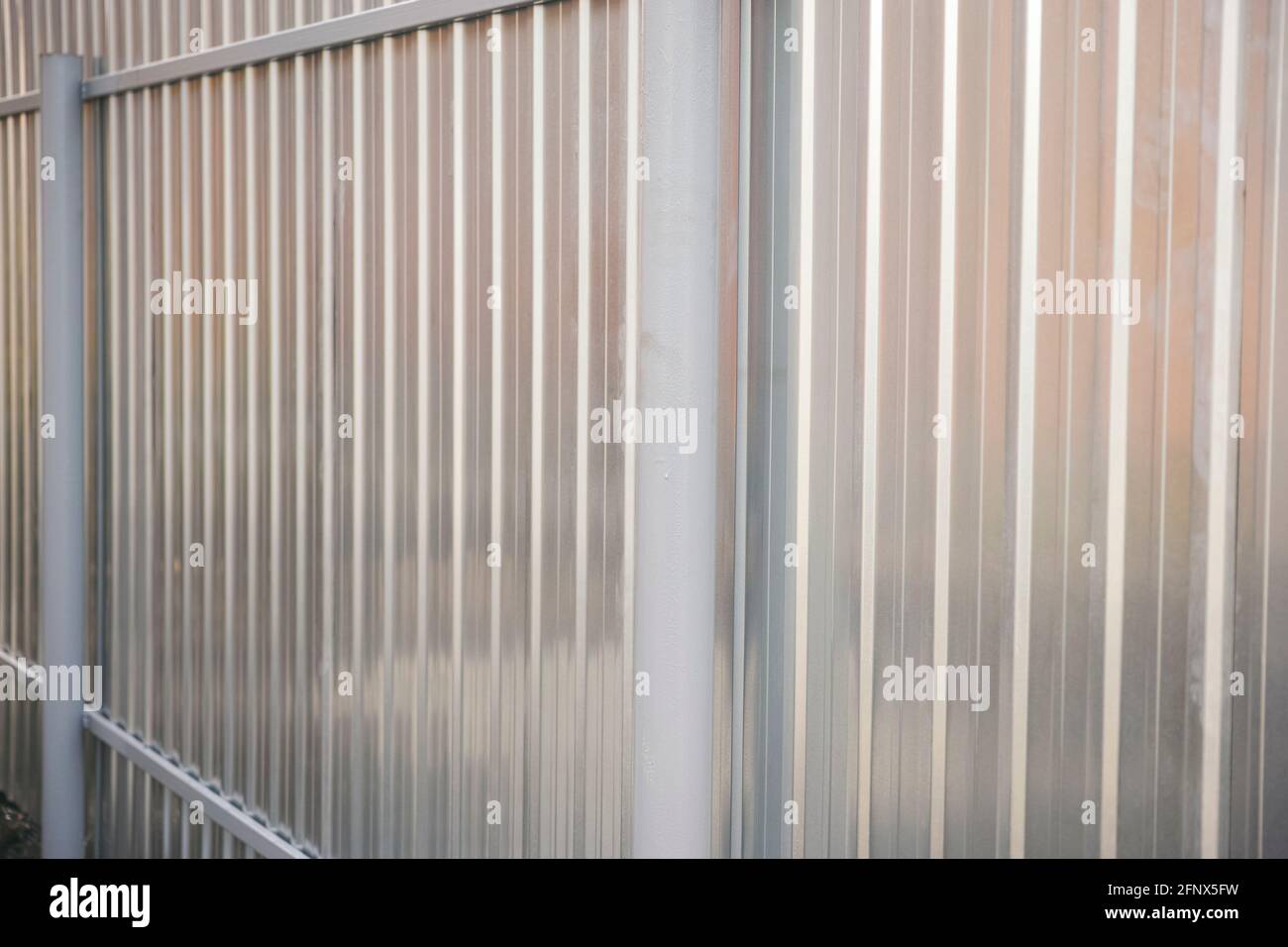 A new metal fence. Close up Stock Photo - Alamy