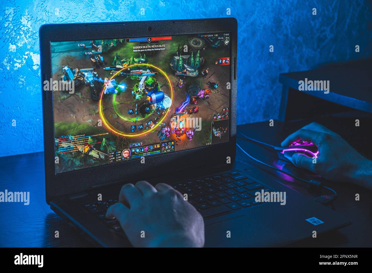Person playing league of legends video game on computer Stock Photo