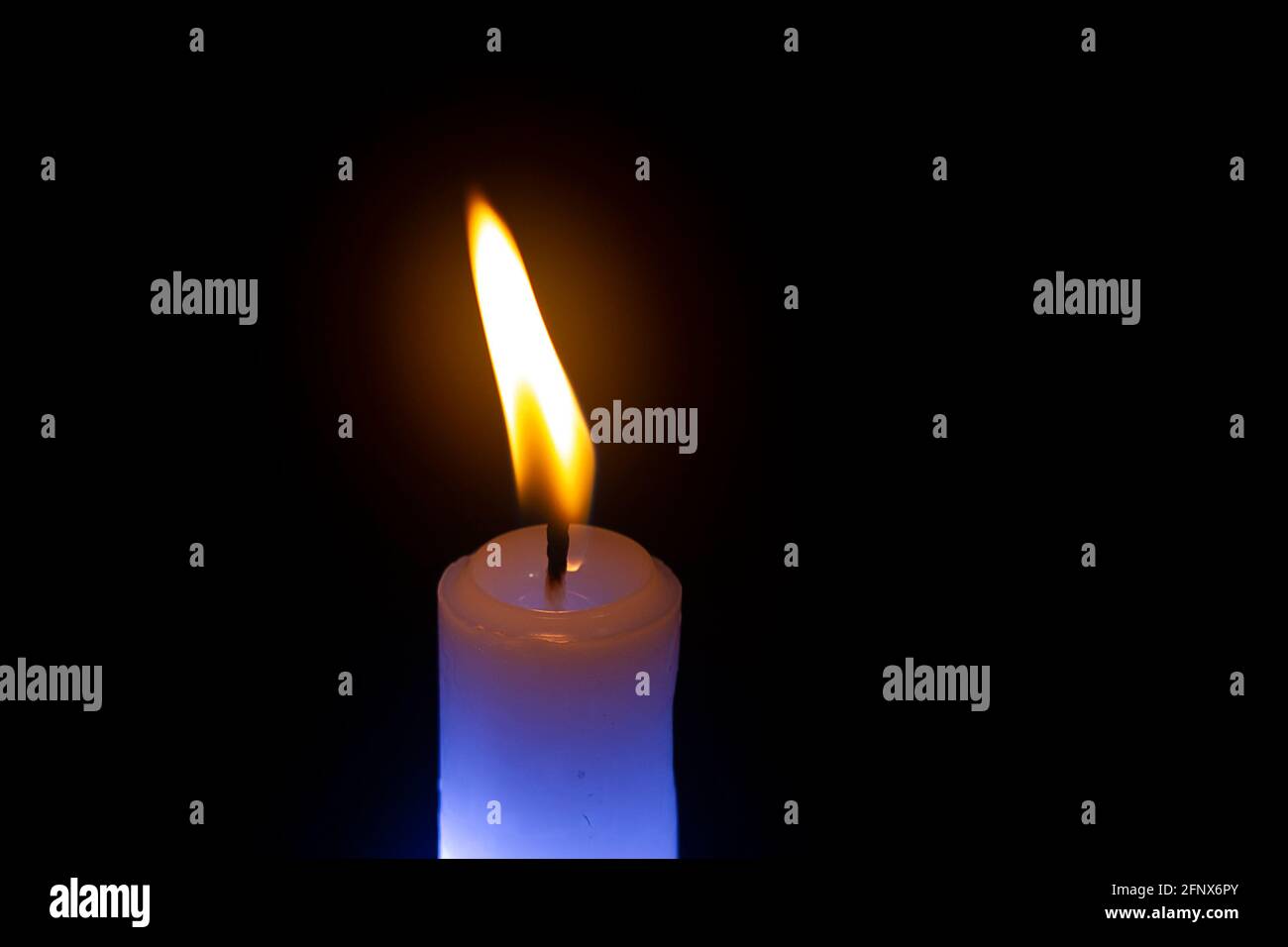 Candle burning in the dark Stock Photo Alamy