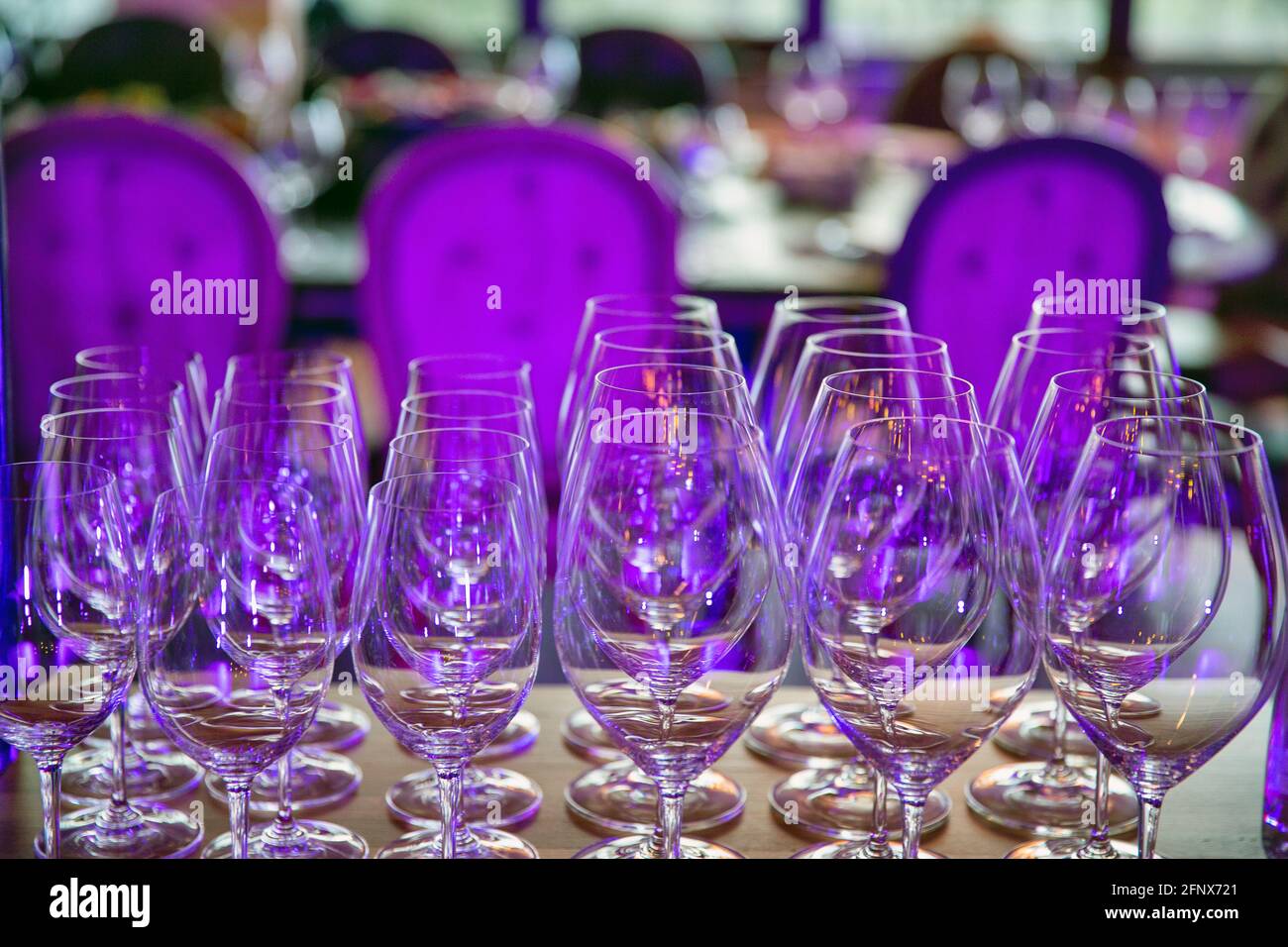 Set of empty wine glasses closeup in violet light Stock Photo