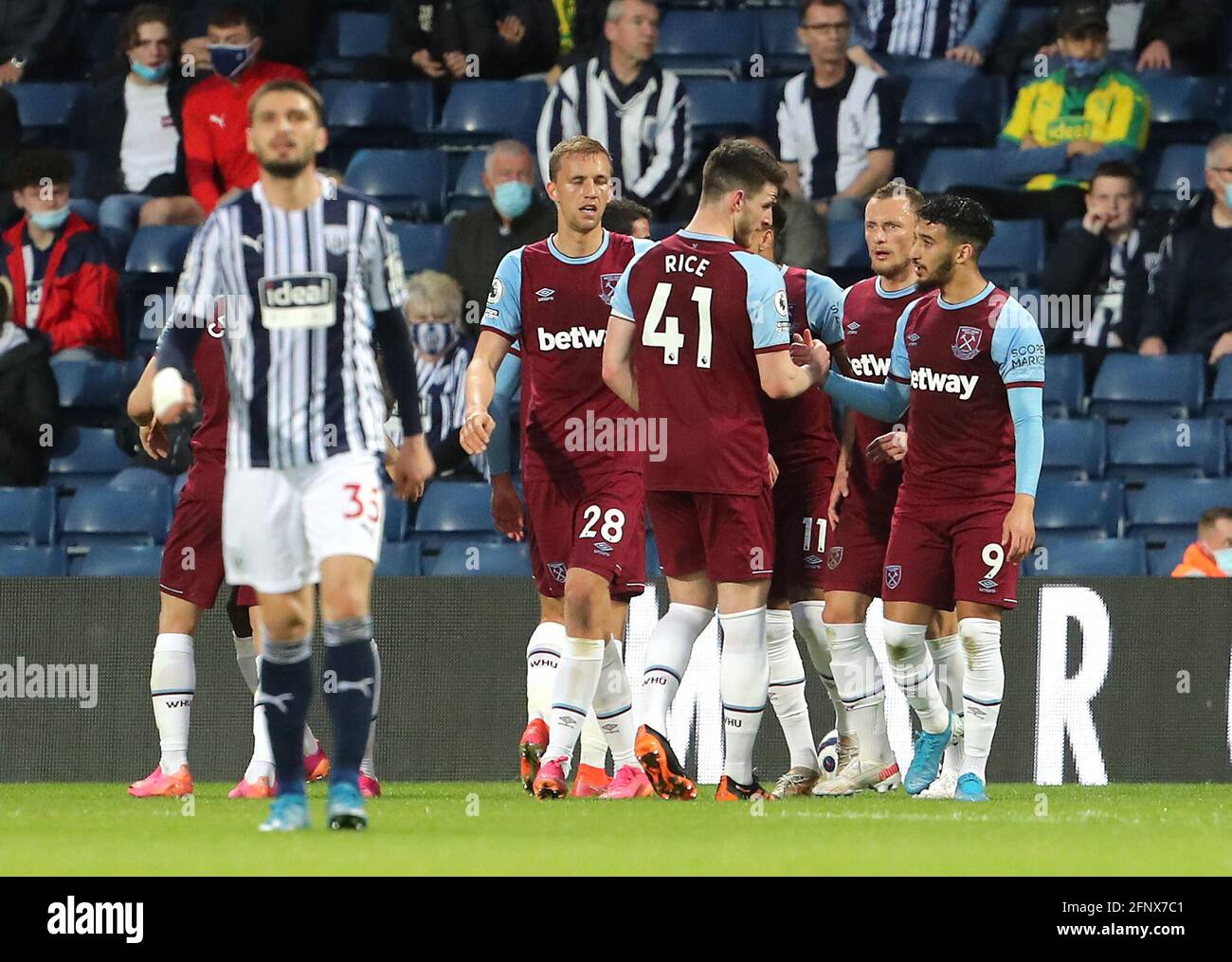 West Ham United's Tomas Soucek (centre) celebrates scoring their side's first goal of the game with team-mates as West Bromwich Albion's Okay Yokuslu looks dejected during the Premier League match at The Hawthorns, West Bromwich. Picture date: Wednesday May 19, 2021. Stock Photo