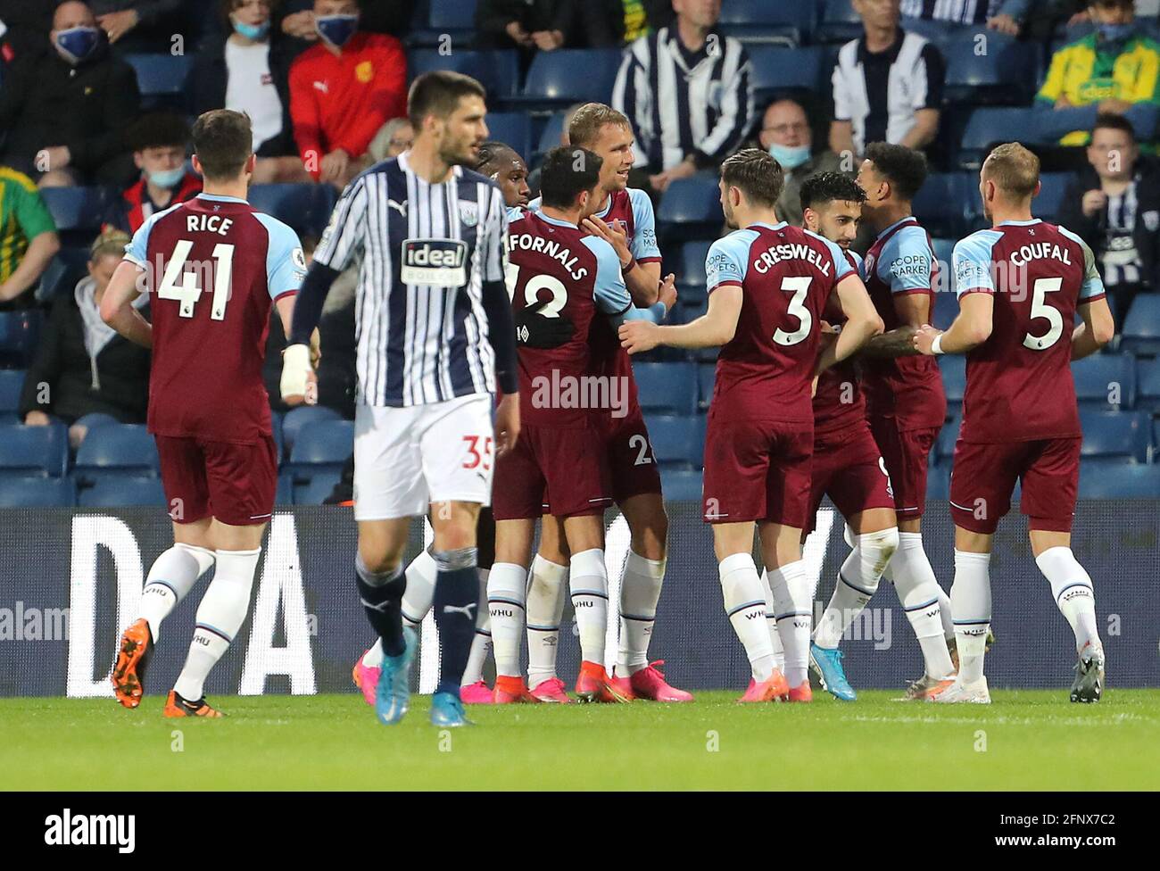 West Ham United's Tomas Soucek (centre) celebrates scoring their side's first goal of the game with team-mates as West Bromwich Albion's Okay Yokuslu looks dejected during the Premier League match at The Hawthorns, West Bromwich. Picture date: Wednesday May 19, 2021. Stock Photo