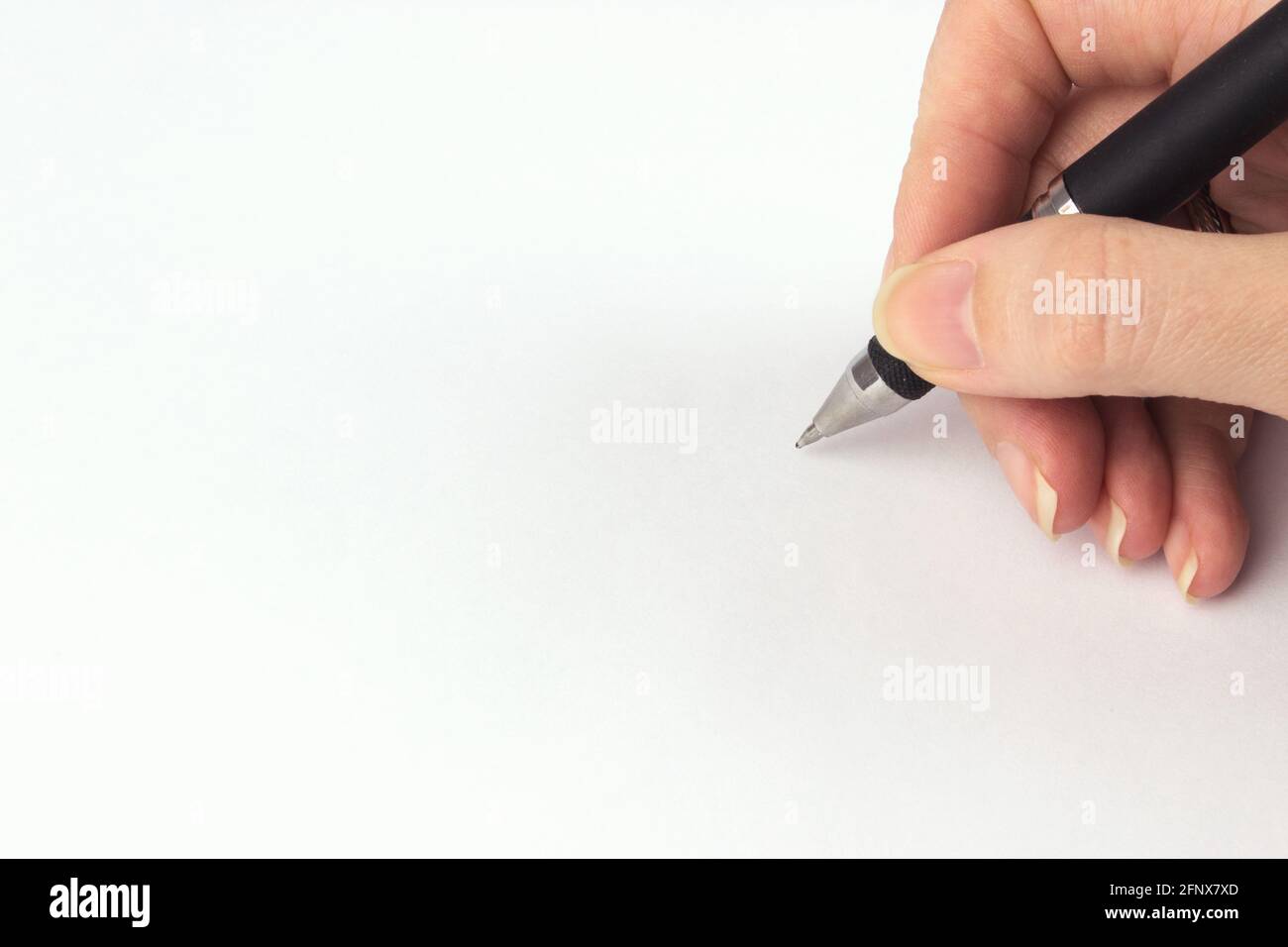 Hand Holding a black pen on empty sheet paper. Ballpoint pen in hand on ...