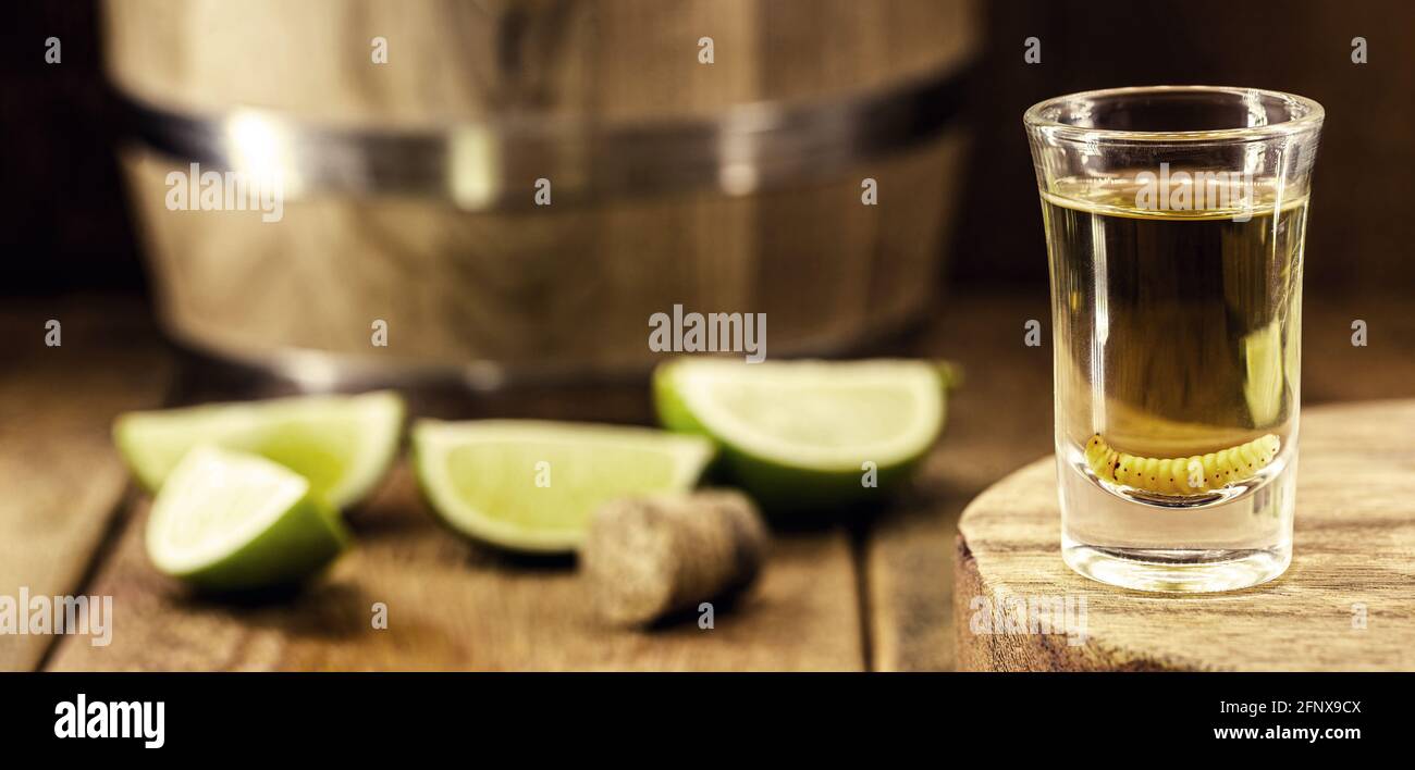 glass and bottle with mezcal (or mescal) is commonly known as tequila