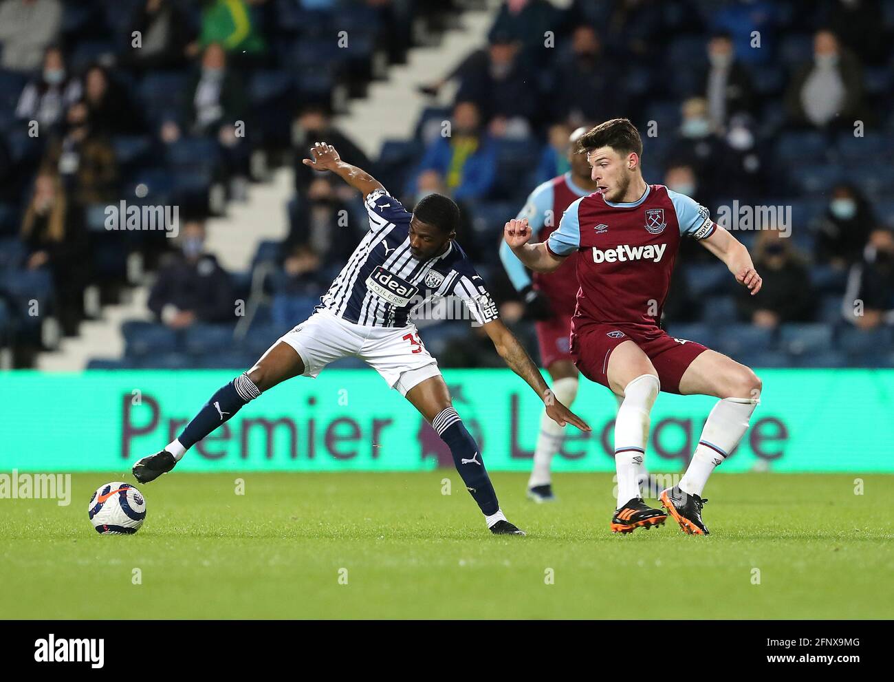 West Bromwich Albion's Ainsley Maitland-Niles (left) and West Ham United's Declan Rice battle for the ball during the Premier League match at The Hawthorns, West Bromwich. Picture date: Wednesday May 19, 2021. Stock Photo