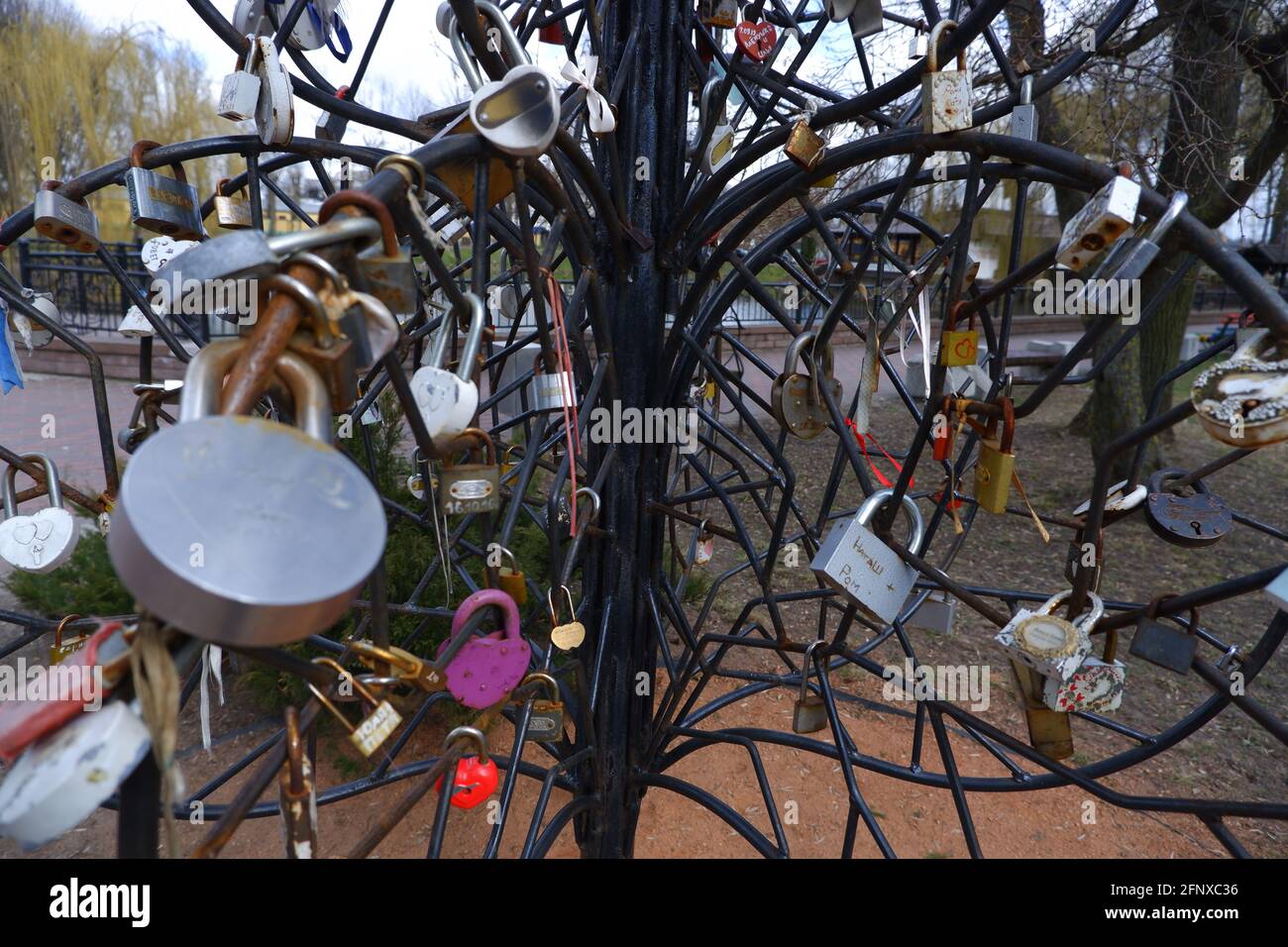 An artificial tree made of iron rods, hung with tourist door locks