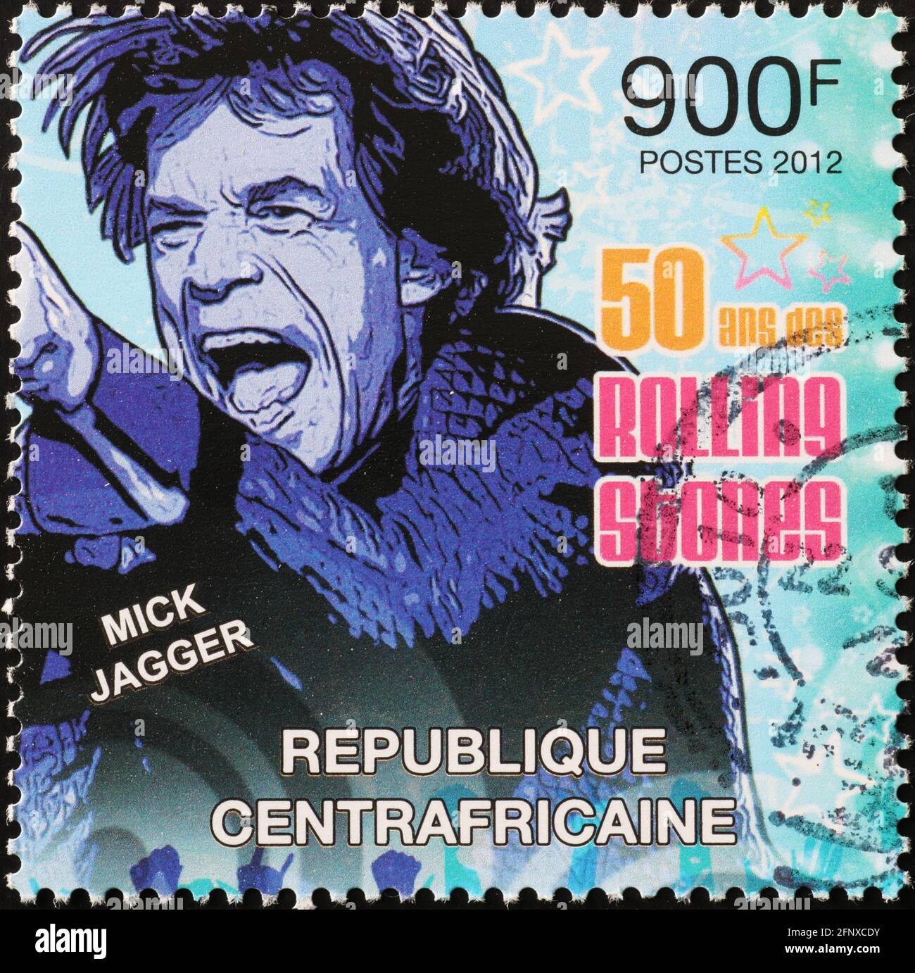 Portrait of Mick Jagger in concert on postage stamp Stock Photo