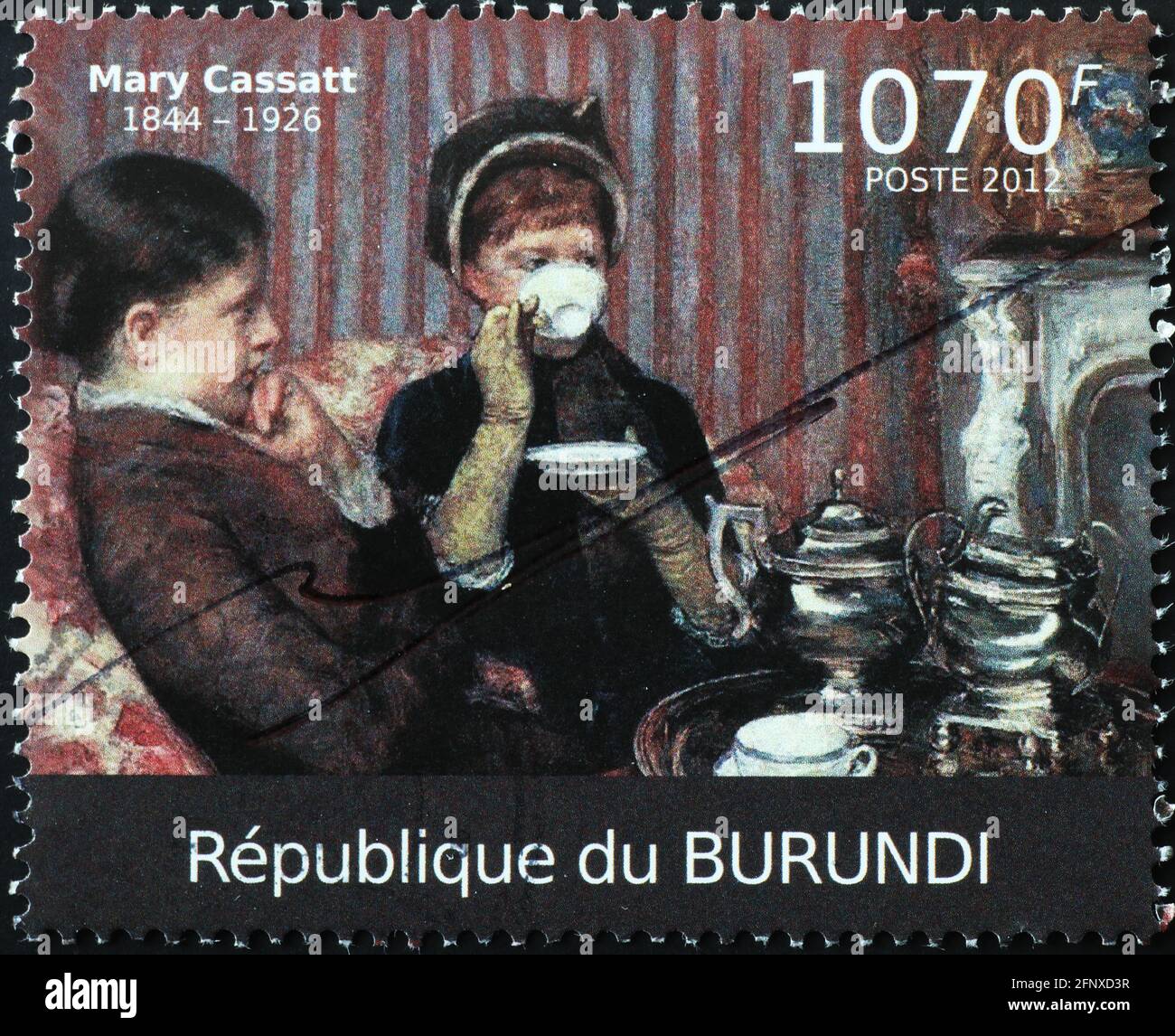 Women drinking tea painted by Mary Cassatt on stamp Stock Photo