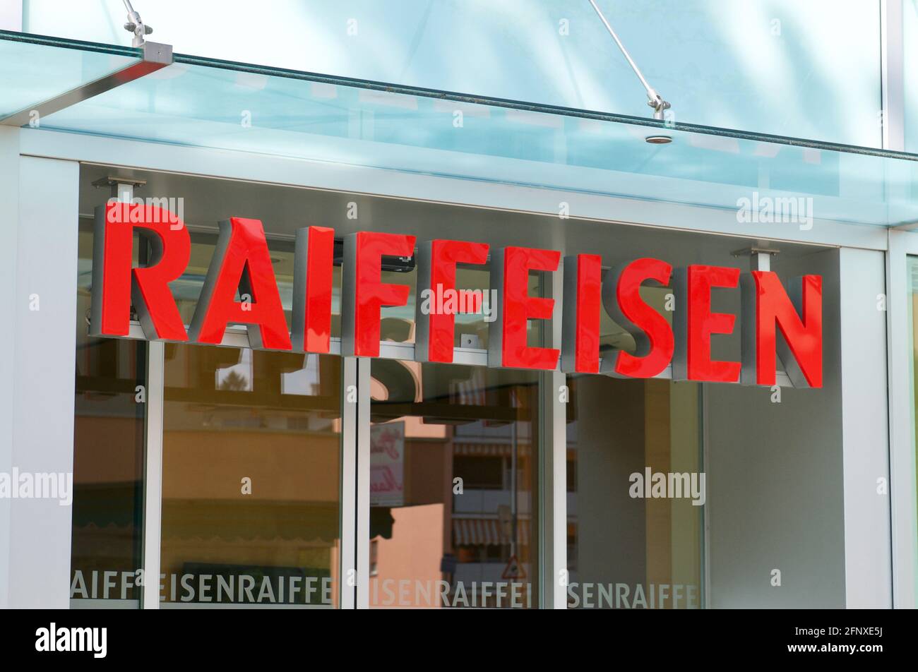 Savosa, Ticino, Switzerland - 25th April 2021 : Raiffeisen Bank sign hanging at the building entrance in Savosa. Raiffeisen is a Swiss cooperative ban Stock Photo