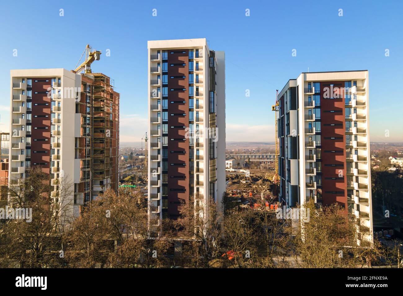 Aerial view of high tower crane and residential apartment buildings ...