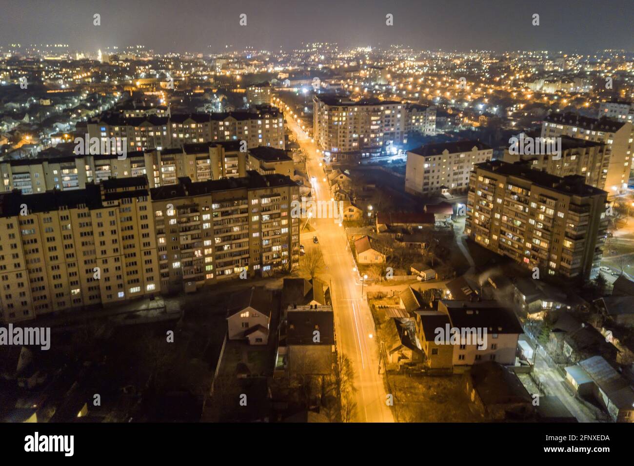 High rise apartment buildings with illuminated windows in city ...