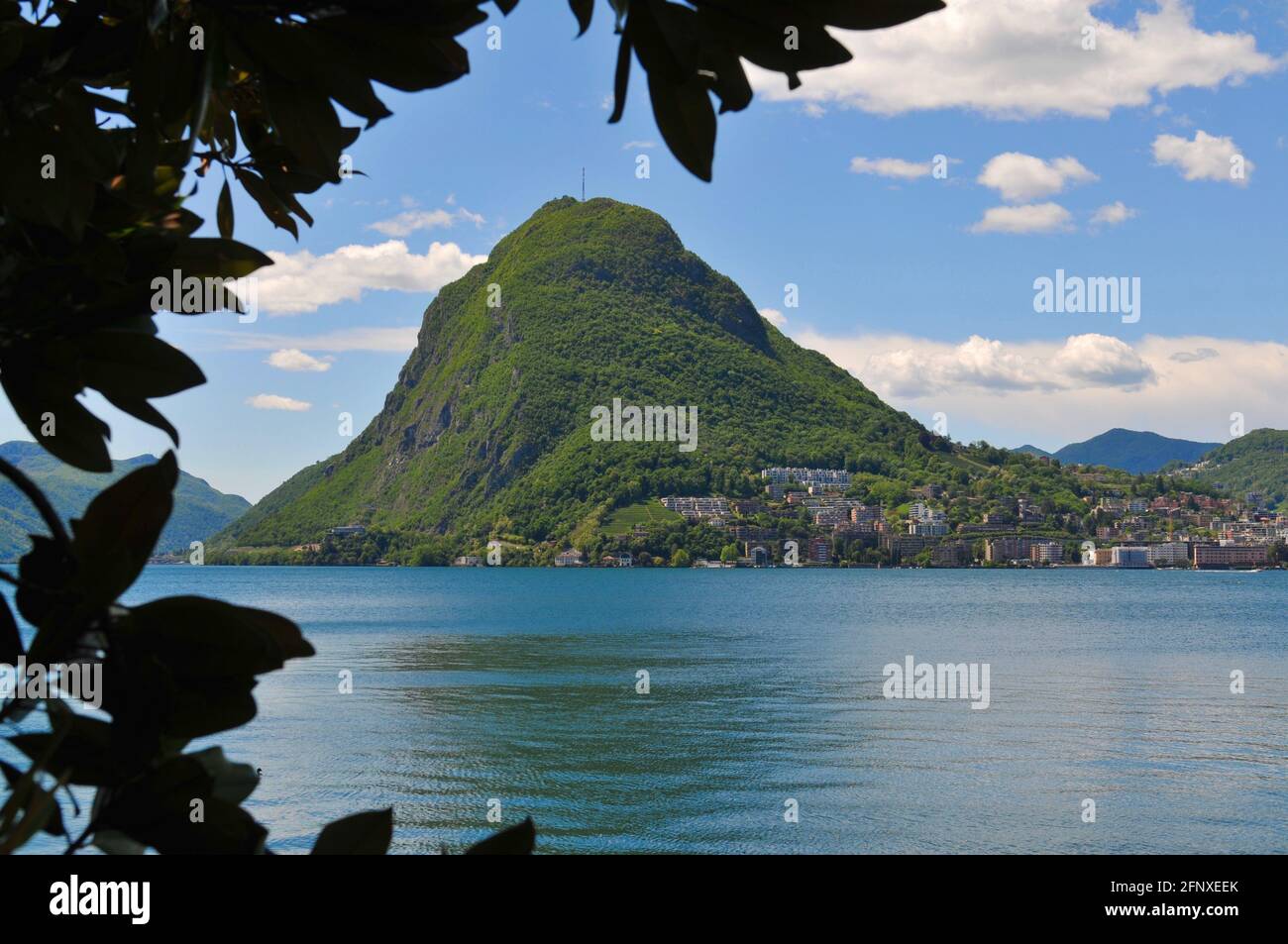 Lanscape view of the beautiful Monte San Salvatore (also known as Mount San Salvatore) and the lake Lugano on a sunny day Stock Photo
