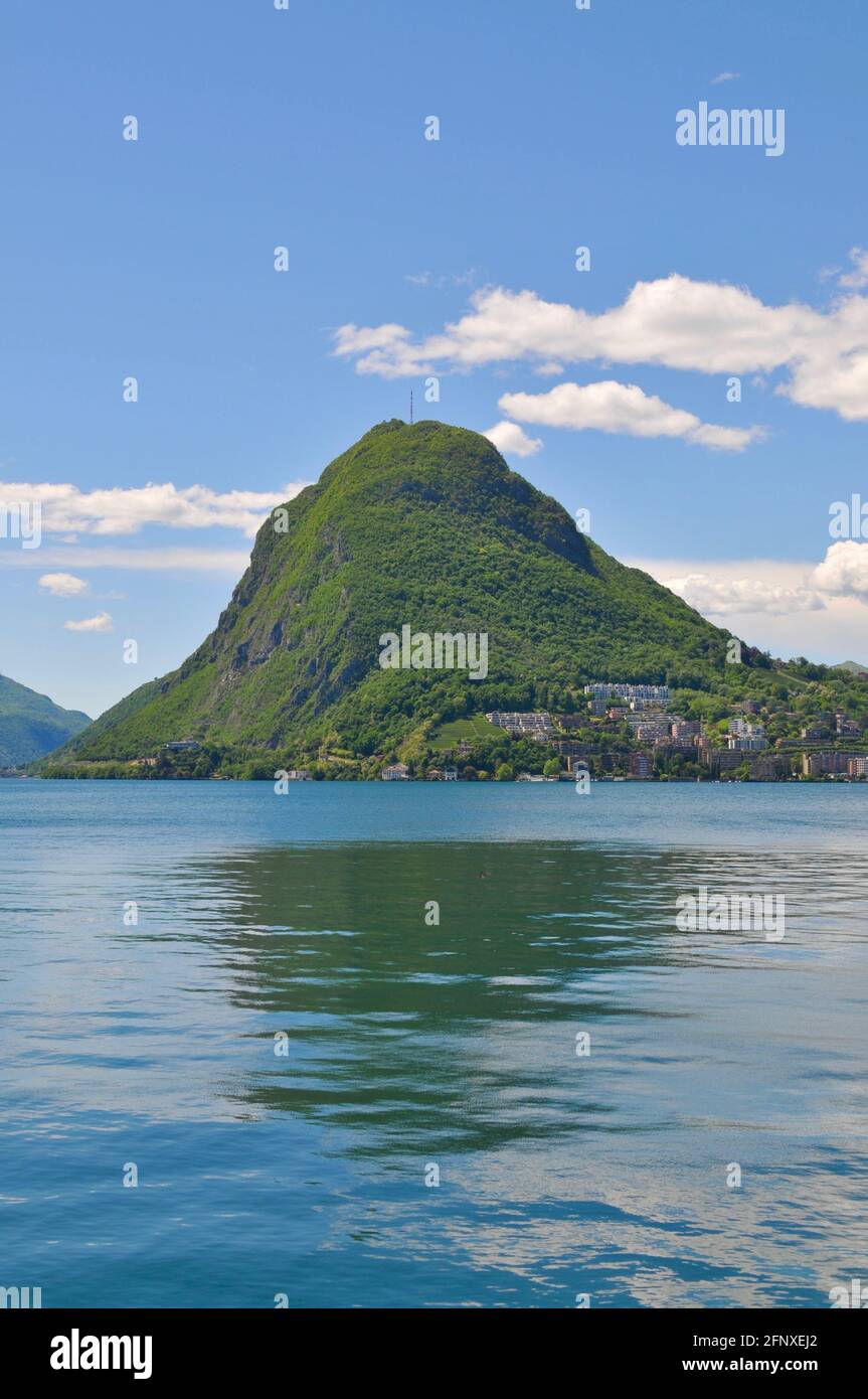 Portrait view of the beautiful Monte San Salvatore (also known as Mount San Salvatore) and the lake Lugano on a sunny day Stock Photo