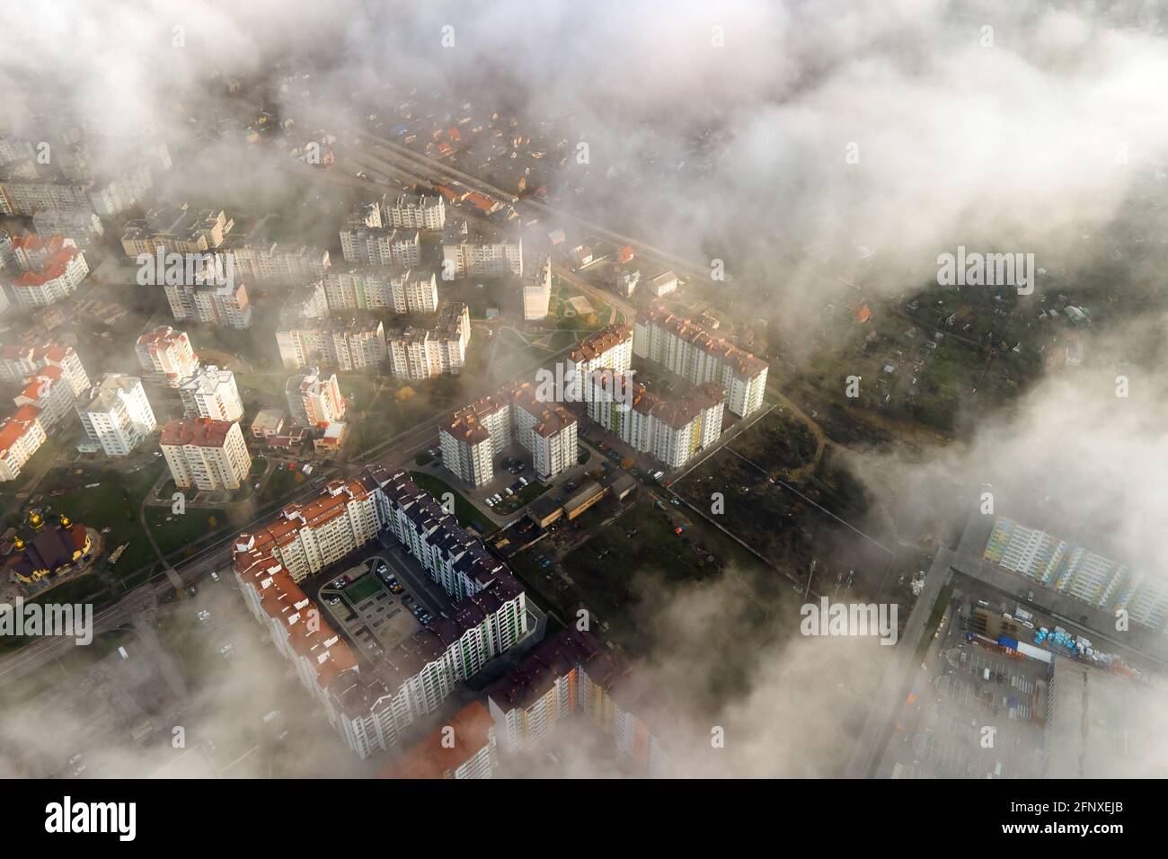 Top aerial view of fluffy white clouds over modern city with high rise ...
