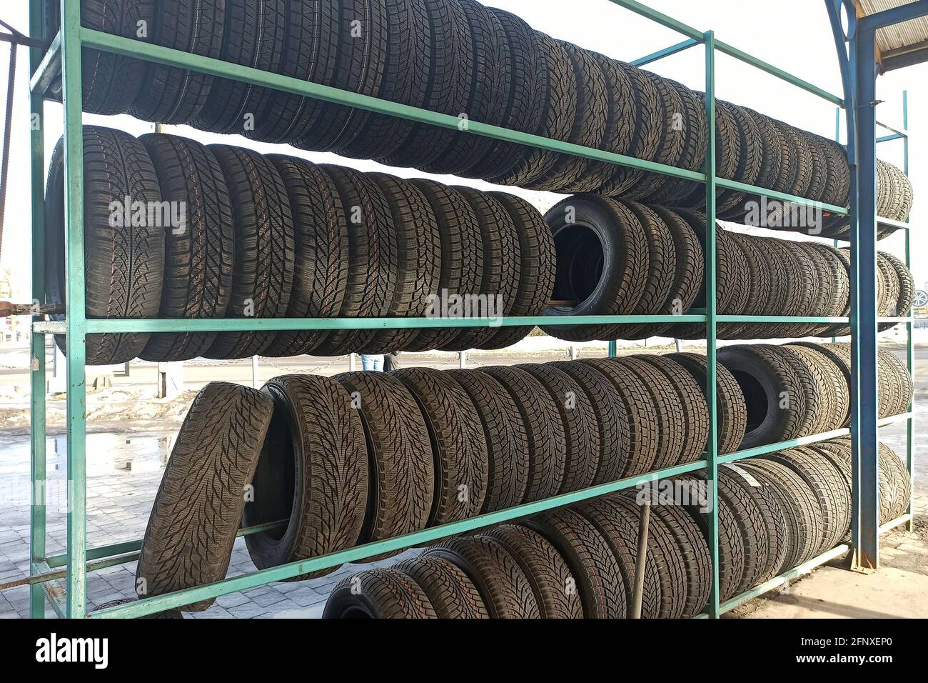Many black rubber car tires on store shelf for sale Stock Photo Alamy