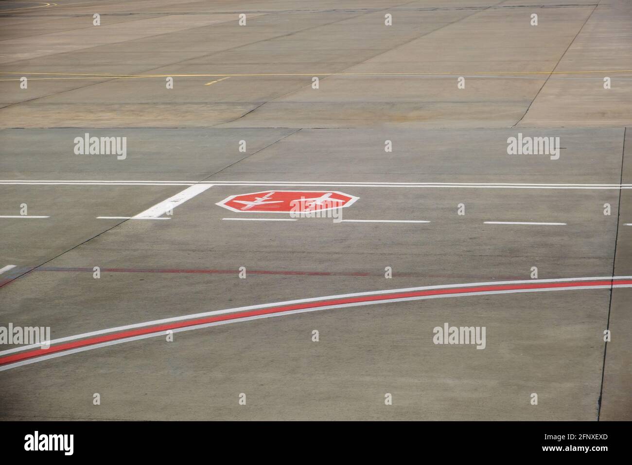Road sign markings on runway surface for airplane taxiing traffic Stock
