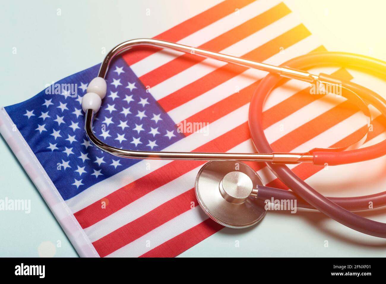 USA medicine background. Stethoscope on the American flag. Healthcare and medical services in the USA concept. High quality photo Stock Photo