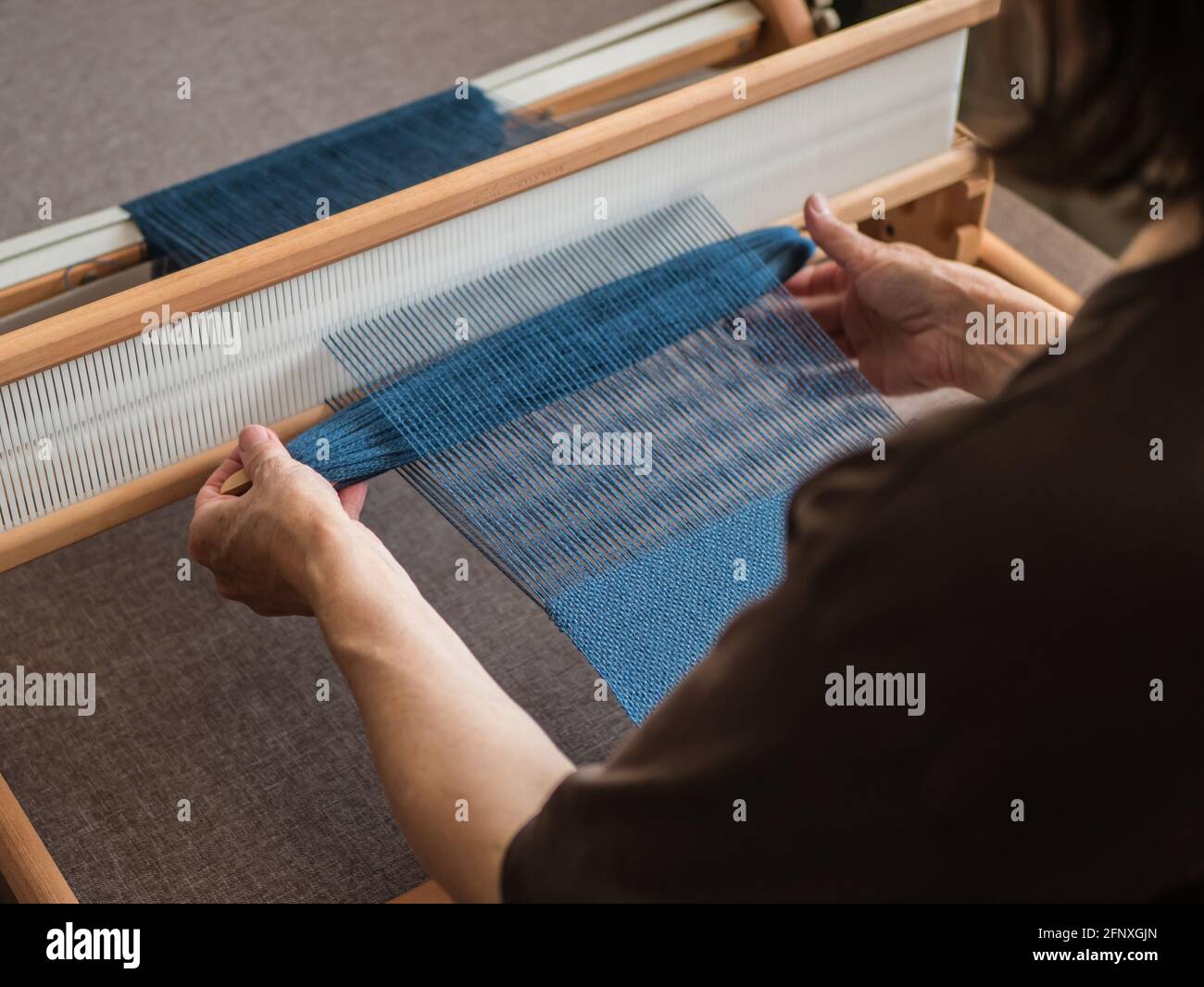 Woman is weaving a fabric. Single shuttle loom Stock Photo Alamy