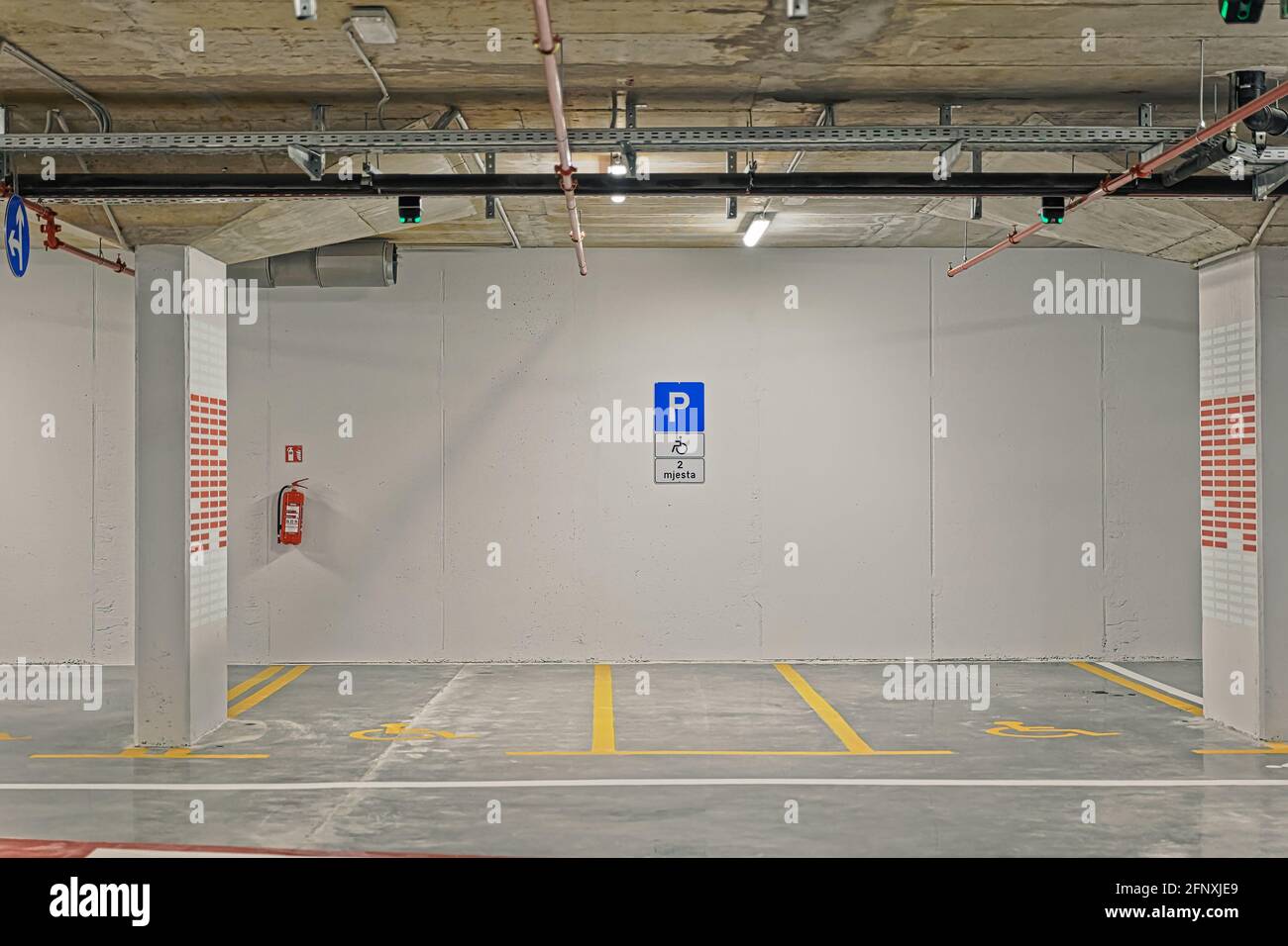 Public underground garage interior with parking spaces for disabled people Stock Photo