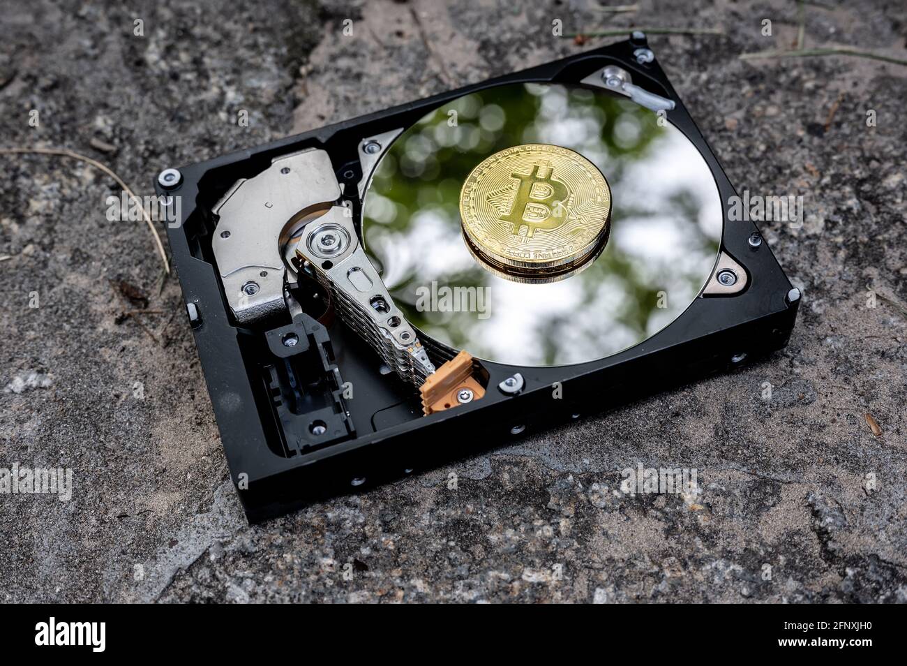 View on a hard disk drive on a concrete surface on a sunny day. Stock Photo