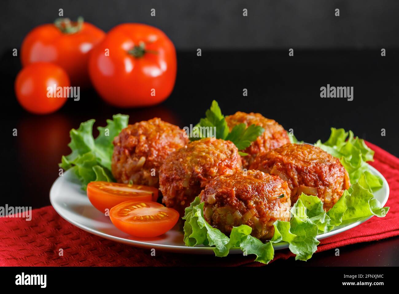 Meat balls in tomato sauce on a black background. Homemade protein meal