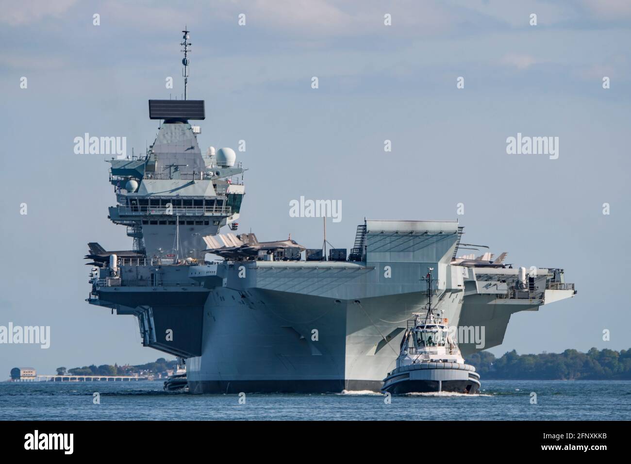 The aircraft carrier HMS Queen Elizabeth (R08) returned to Portsmouth, UK on 19/5/2021 with F-35B fighters and Merlin helicopters on the flight deck. Stock Photo