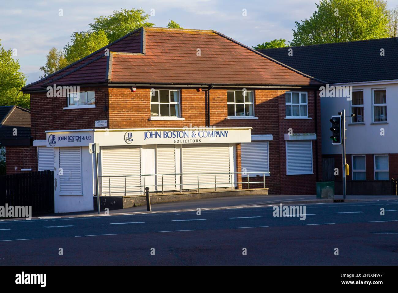 16 May 21 A local firm of solicitors located in East Belfast Northern Ireland closed for the weekend. the premises is protected by steel roller shutte Stock Photo