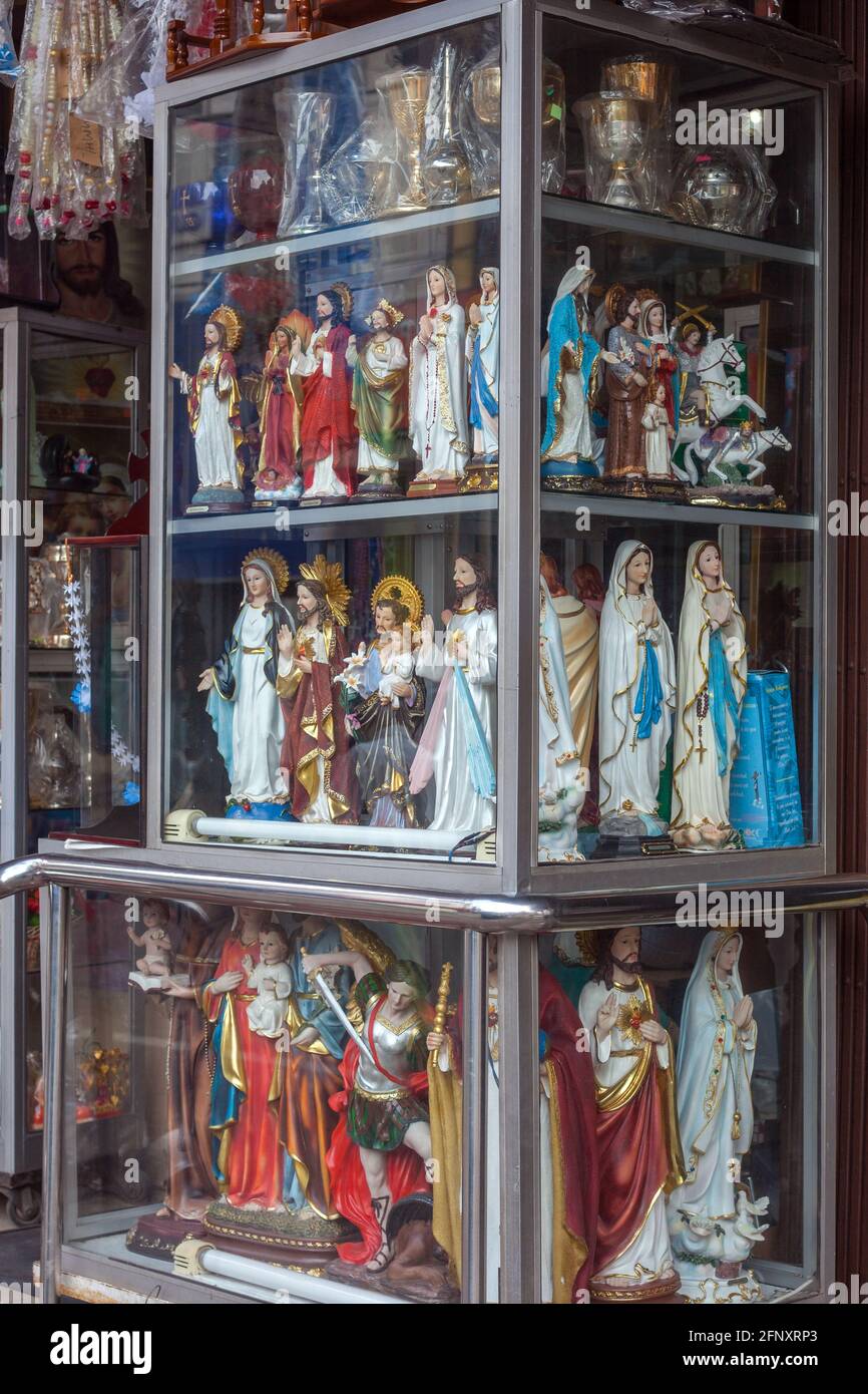 Glass display outside shop containing Jesus, Mary and other