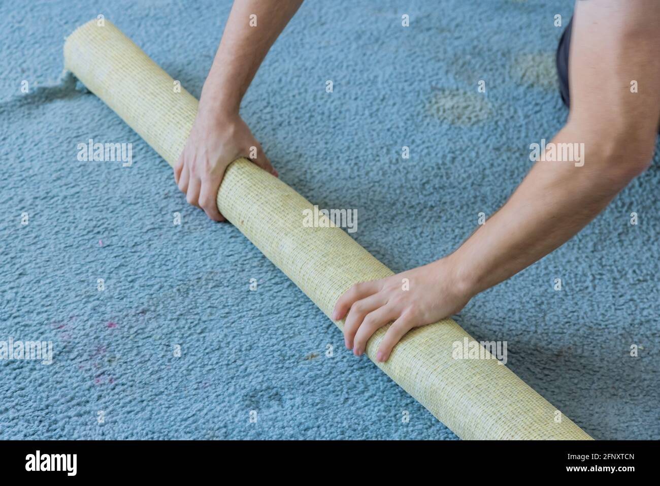 Removing a carpet for renovation works in the apartment Stock Photo